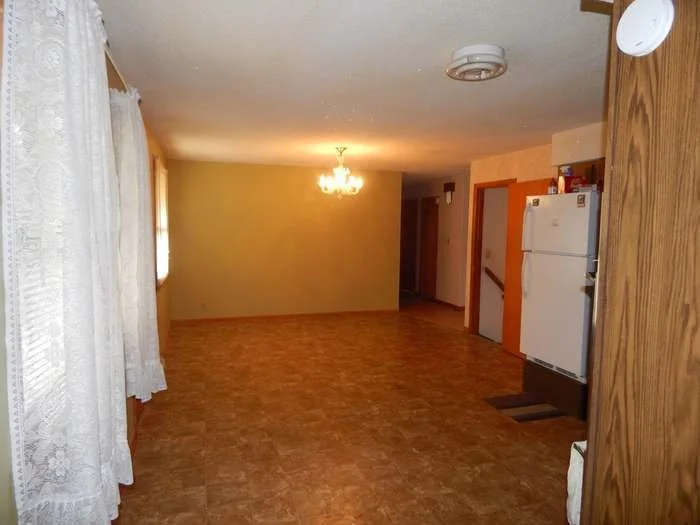 Before photo of an old, worn-out floor prior to a complete remodel by All Phase Flooring LLC in the Oak Grove area.