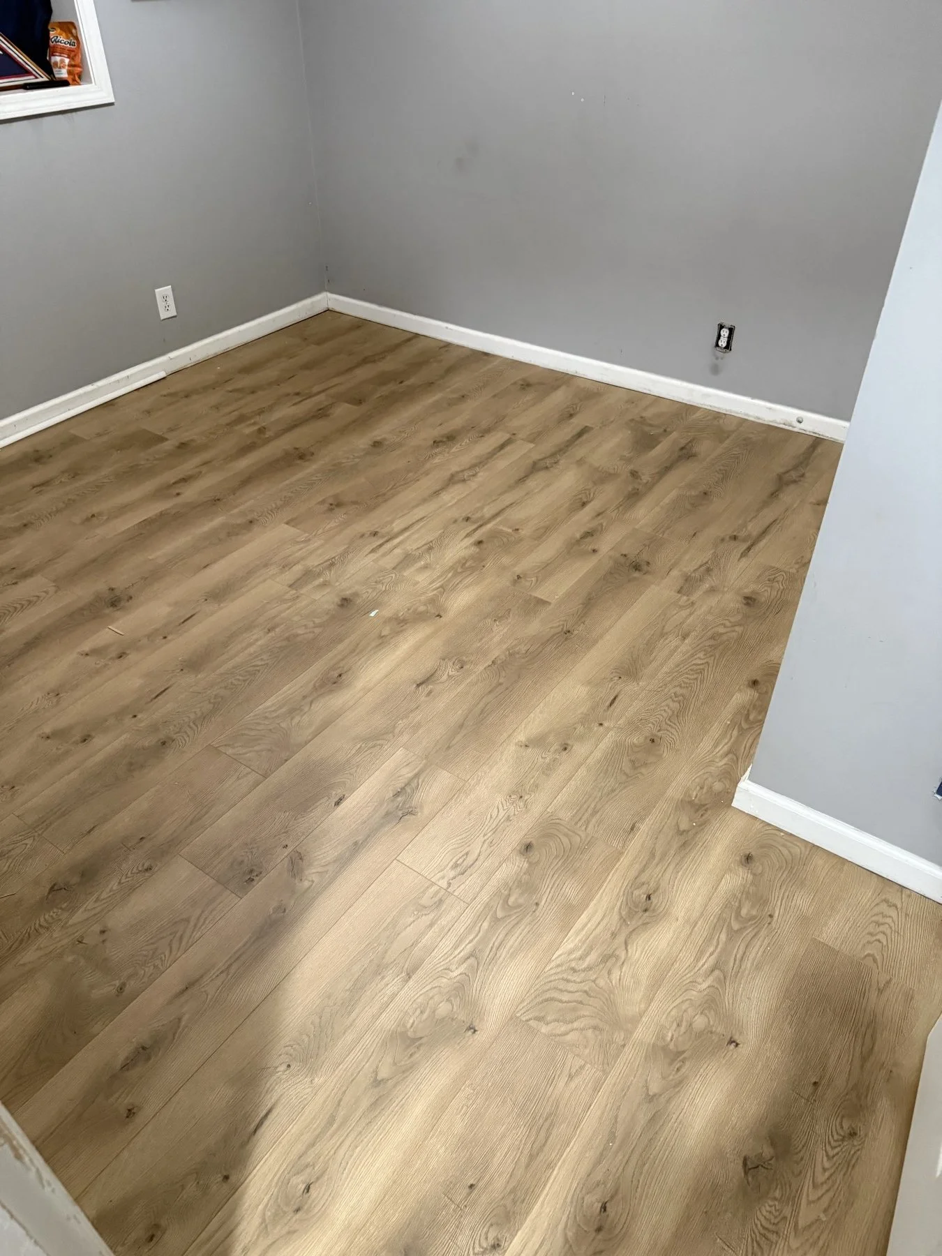 Professional laminate flooring installation in a residential bedroom by All Phase Flooring LLC near Fort Campbell.