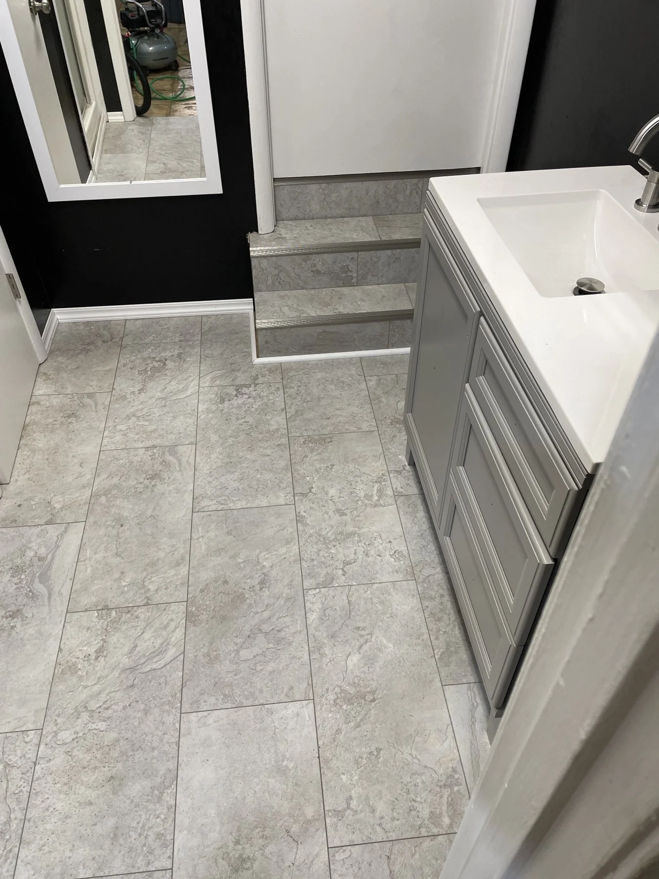 Finished luxury vinyl tile flooring installation in a renovated bathroom by All Phase Flooring LLC in Clarksville, TN.