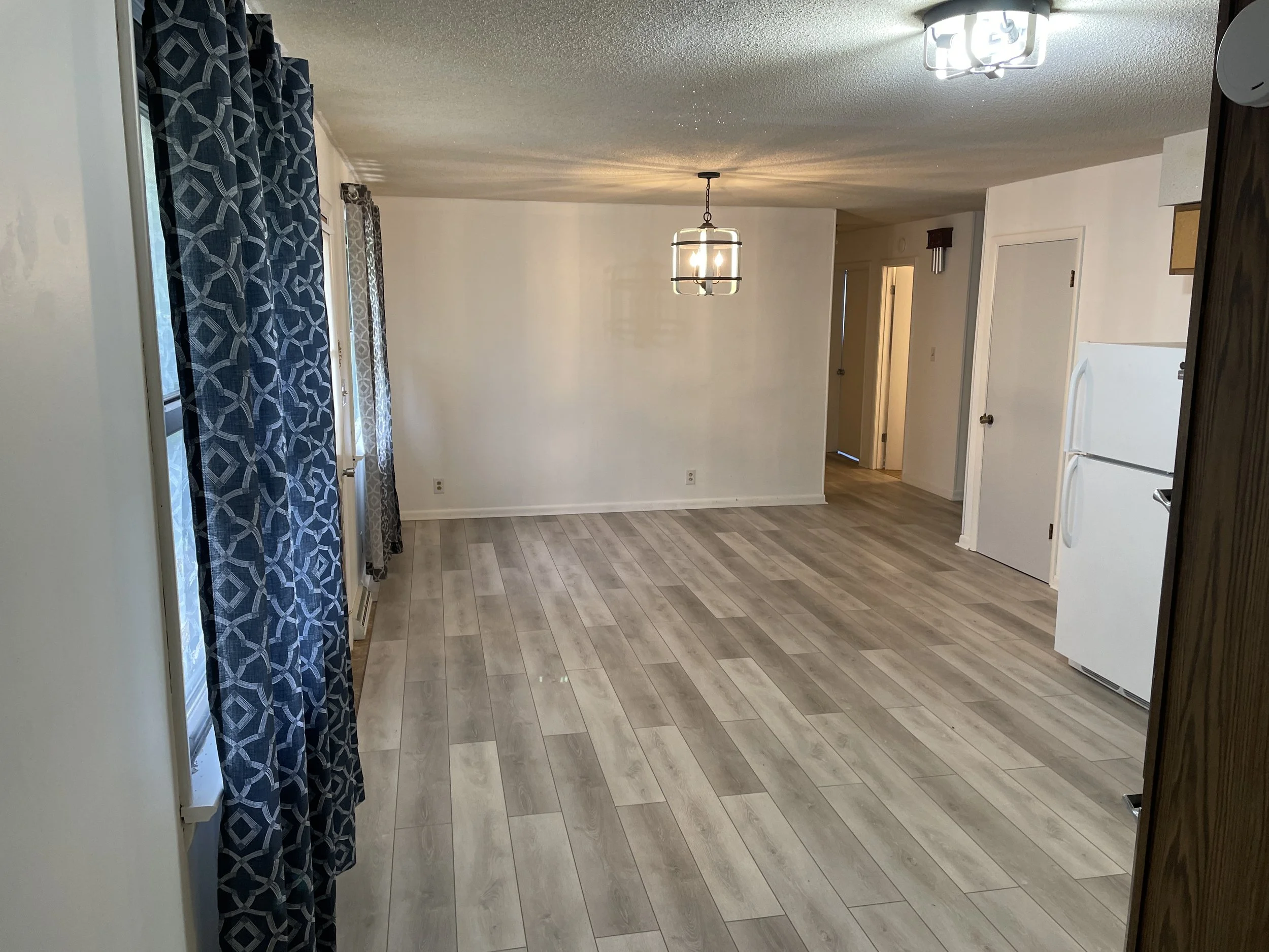 After photo showing a beautiful new wood-look flooring installation completed in Oak Grove, KY by All Phase Flooring LLC.