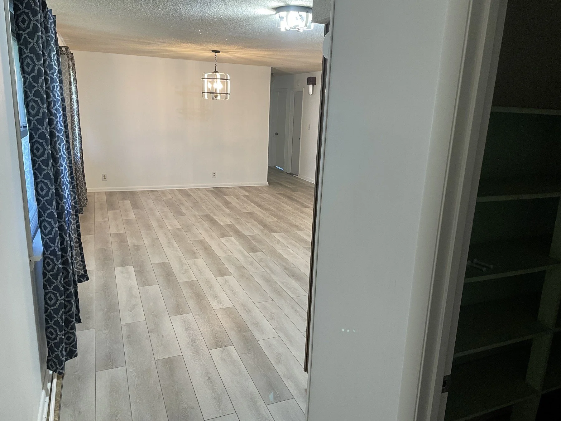 Finished LVP flooring installation in a kitchen and living area by All Phase Flooring LLC.