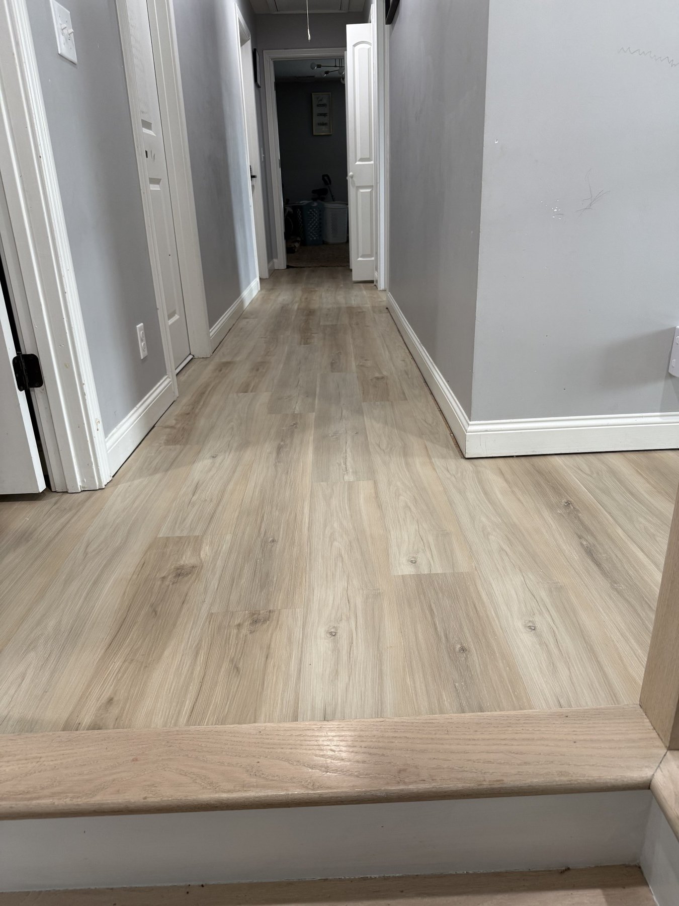 Completed luxury vinyl plank flooring installation in a hallway for a military PCS move-out by All Phase Flooring LLC in Clarksville, Tennessee.