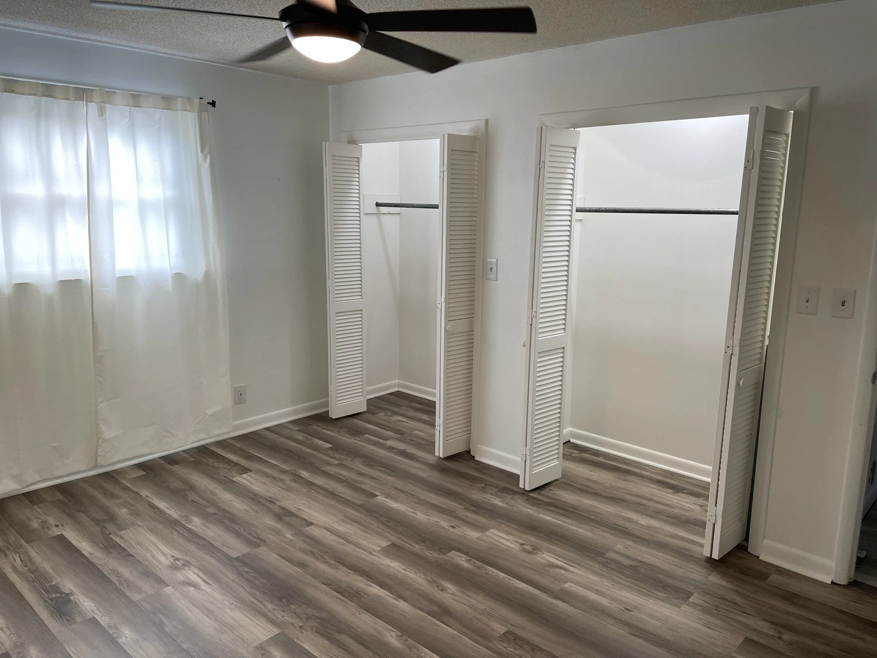 After photo showing a beautiful, bright new flooring installation in a Clarksville bedroom by All Phase Flooring LLC.
