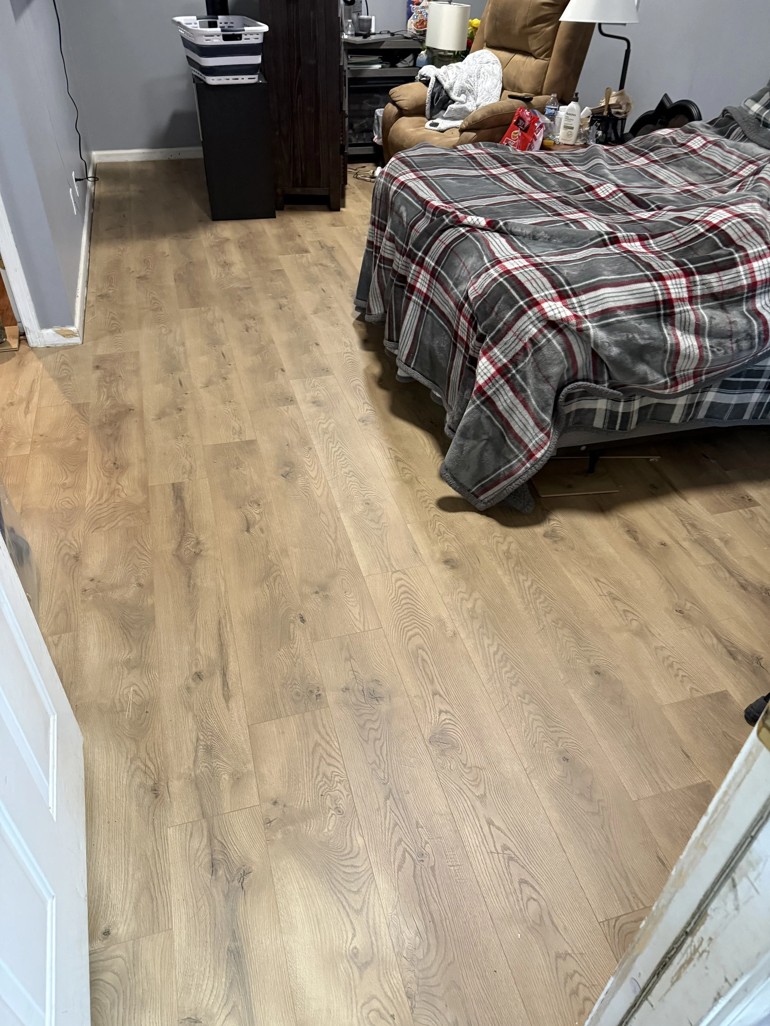 Finished luxury vinyl plank flooring installation after removing old carpet and padding by All Phase Flooring LLC near Fort Campbell.