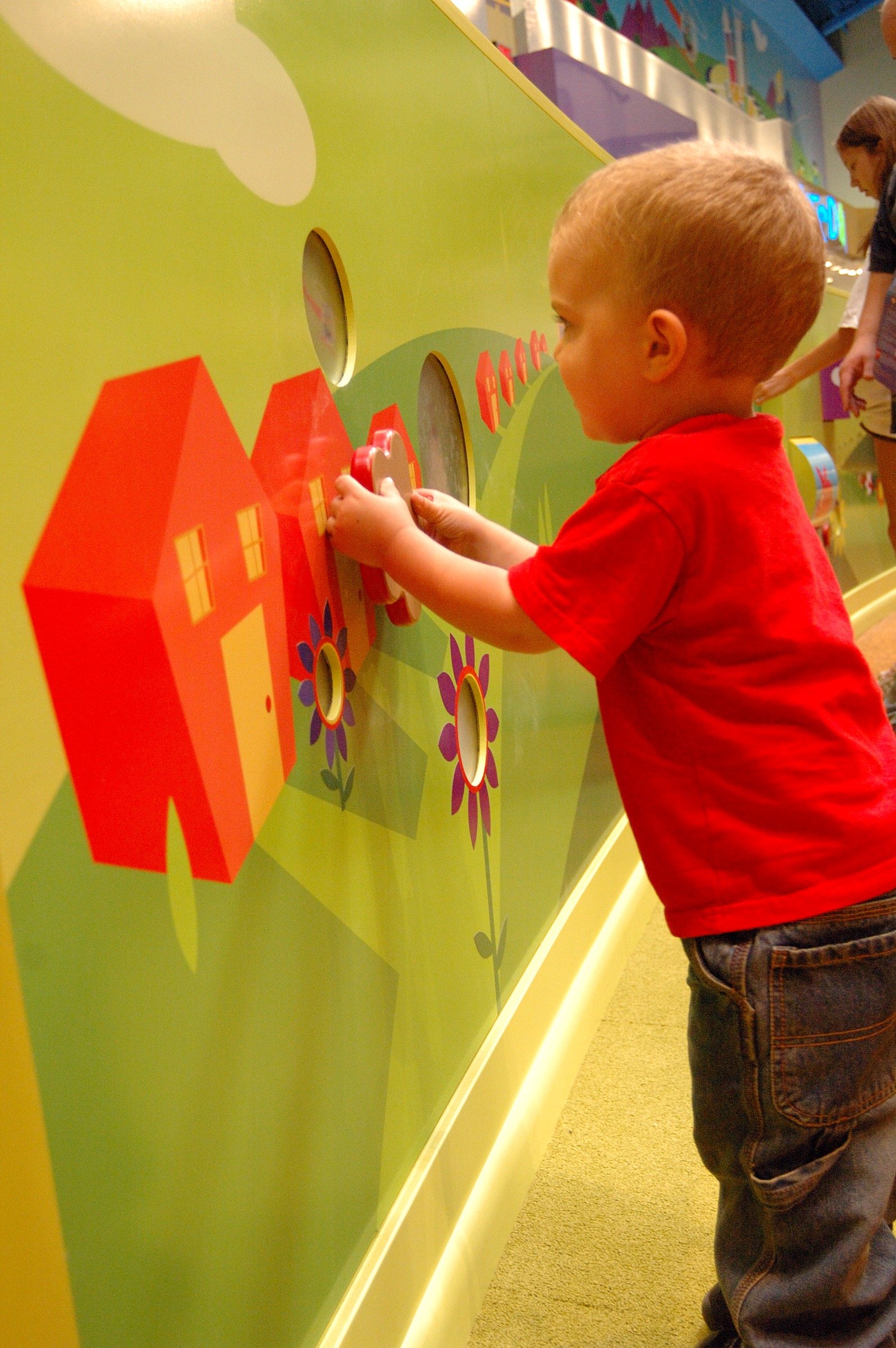 Children playing in the PBS Kids Backyard play zone.
