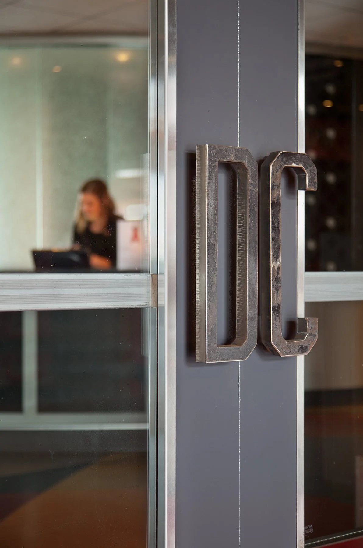 Close-up of the entrance door handles on a glass door 