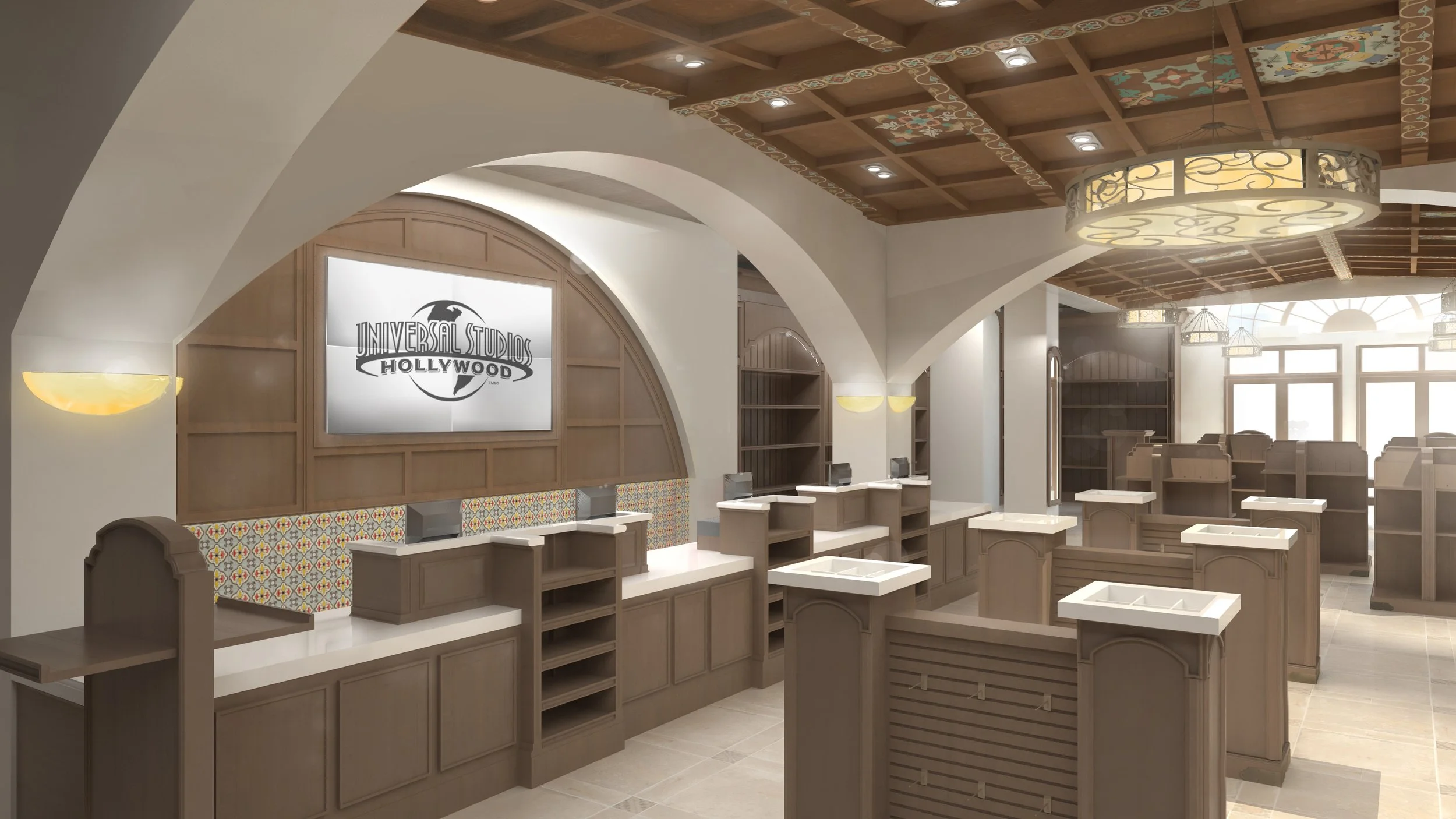 Interior of a movie theater lobby with a Universal Studios Hollywood sign on the wall, decorative wall panels, warm lighting, and empty ticket counters.