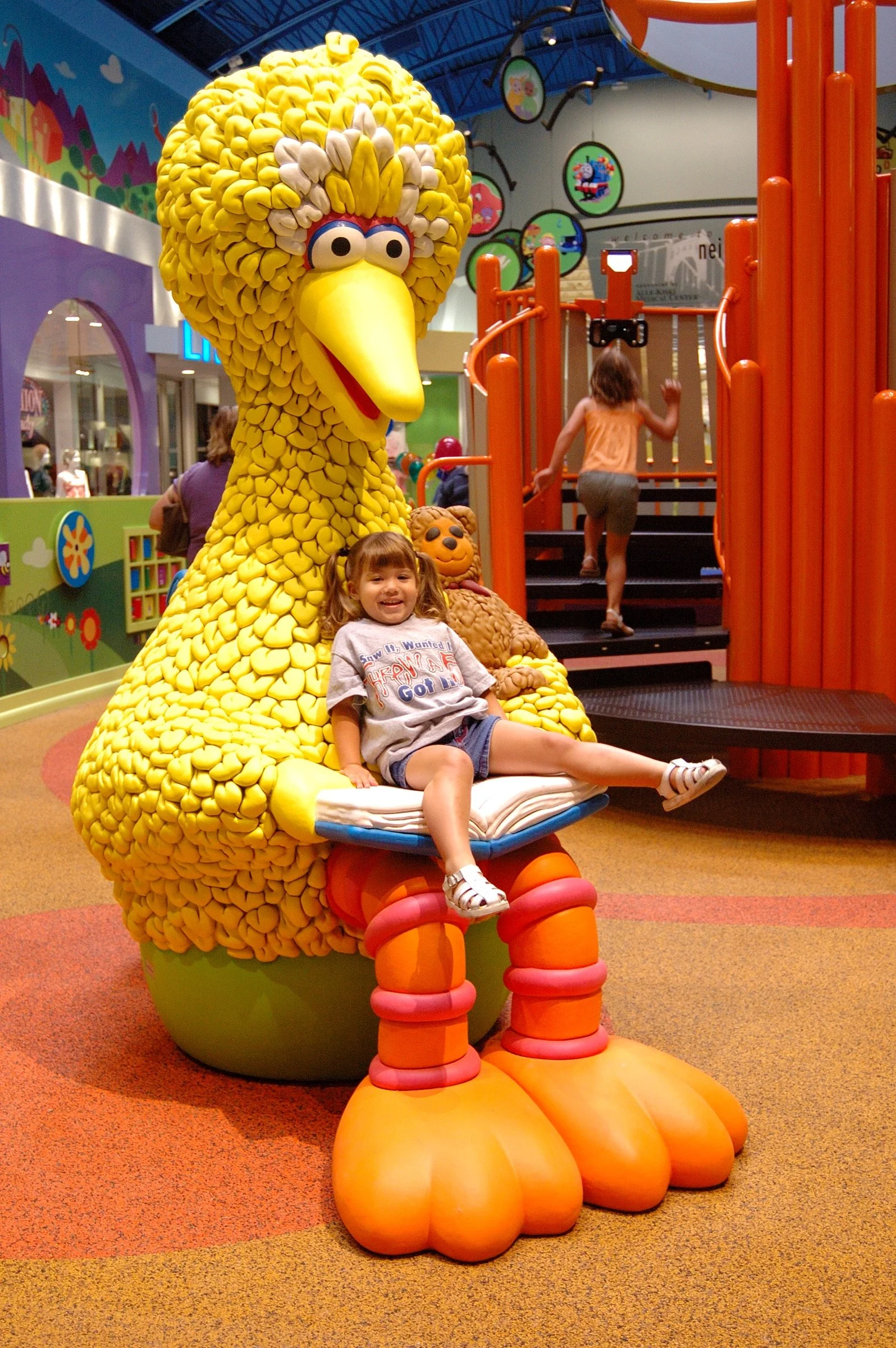 Children playing in the PBS Kids Backyard play zone.