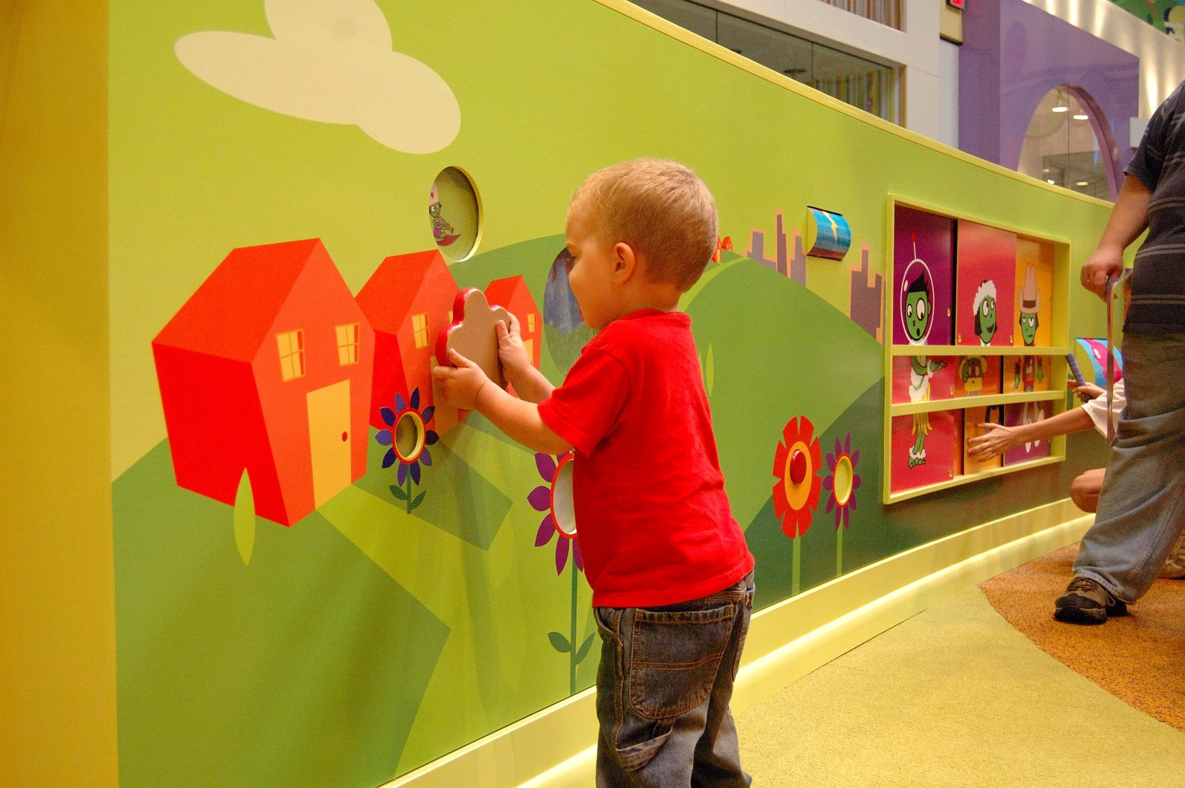 Children playing in the PBS Kids Backyard play zone.
