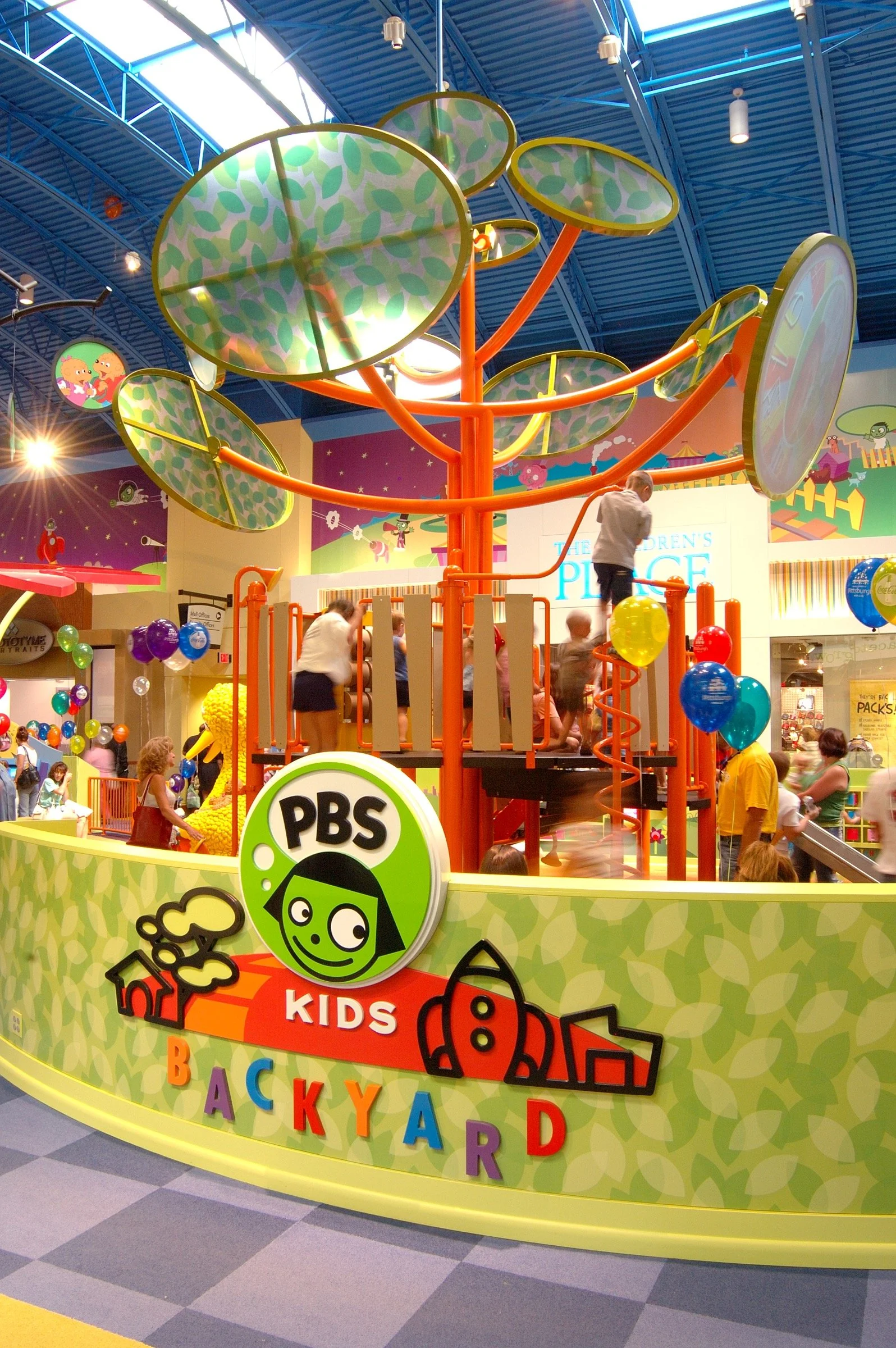  Children playing at PBS Kids Backyard play zone
