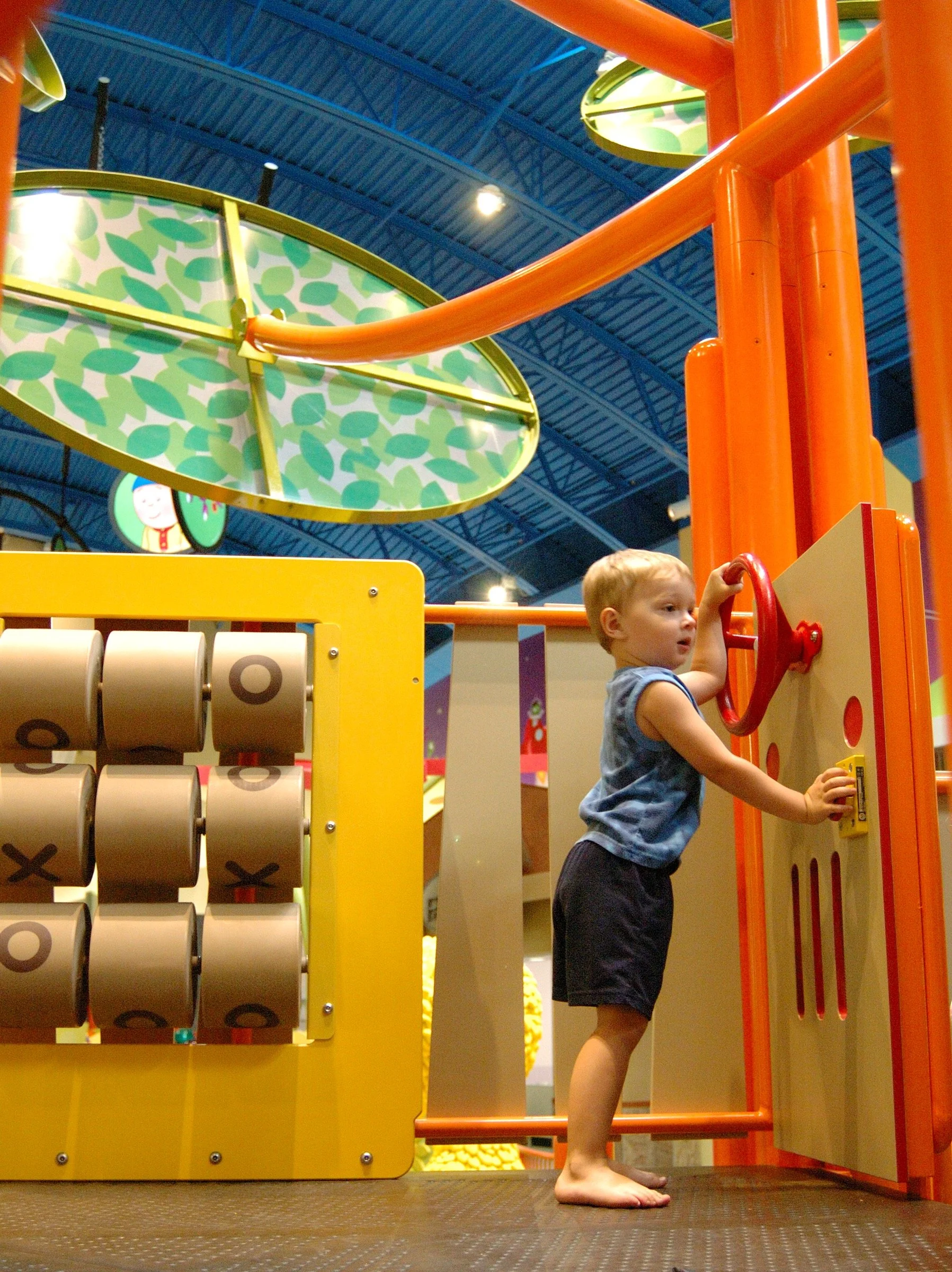 Children playing in the PBS Kids Backyard play zone.