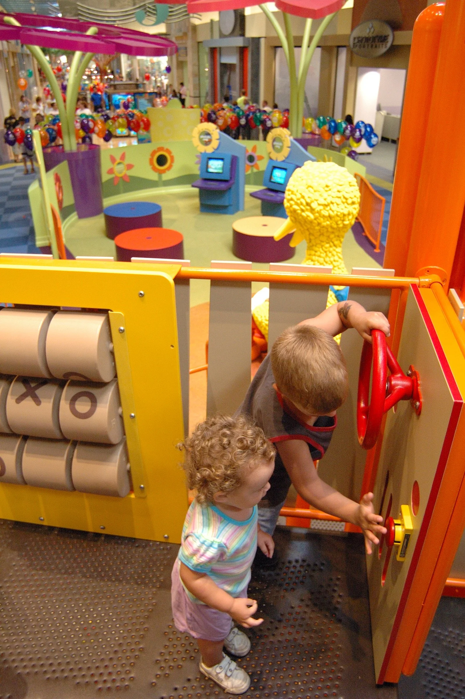 Children playing in the PBS Kids Backyard play zone.