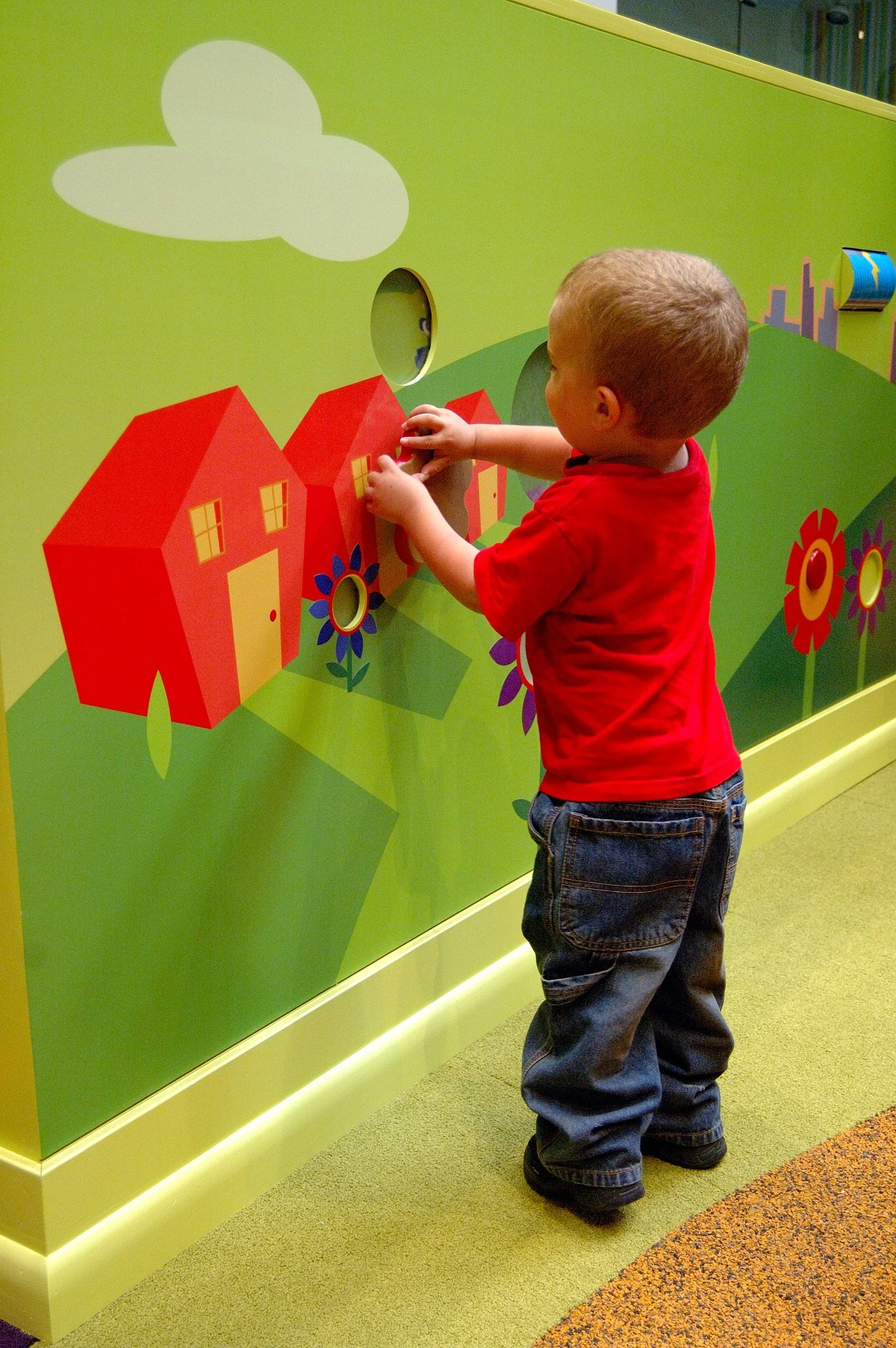 Children playing in the PBS Kids Backyard play zone.