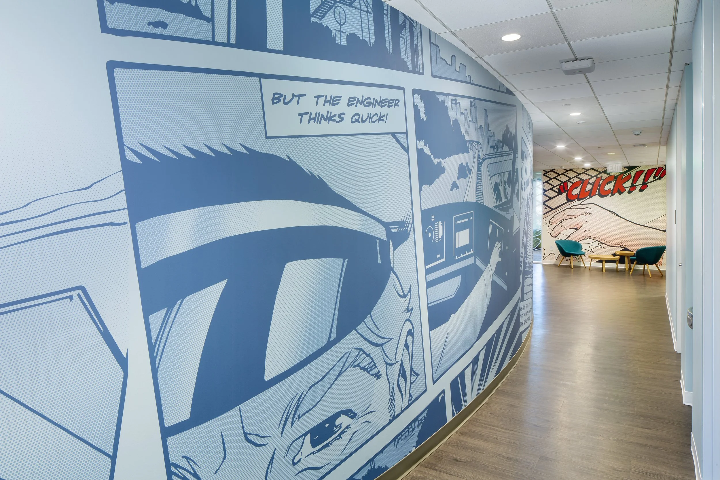 A office hallway with a blue comic book style mural on one wall. 