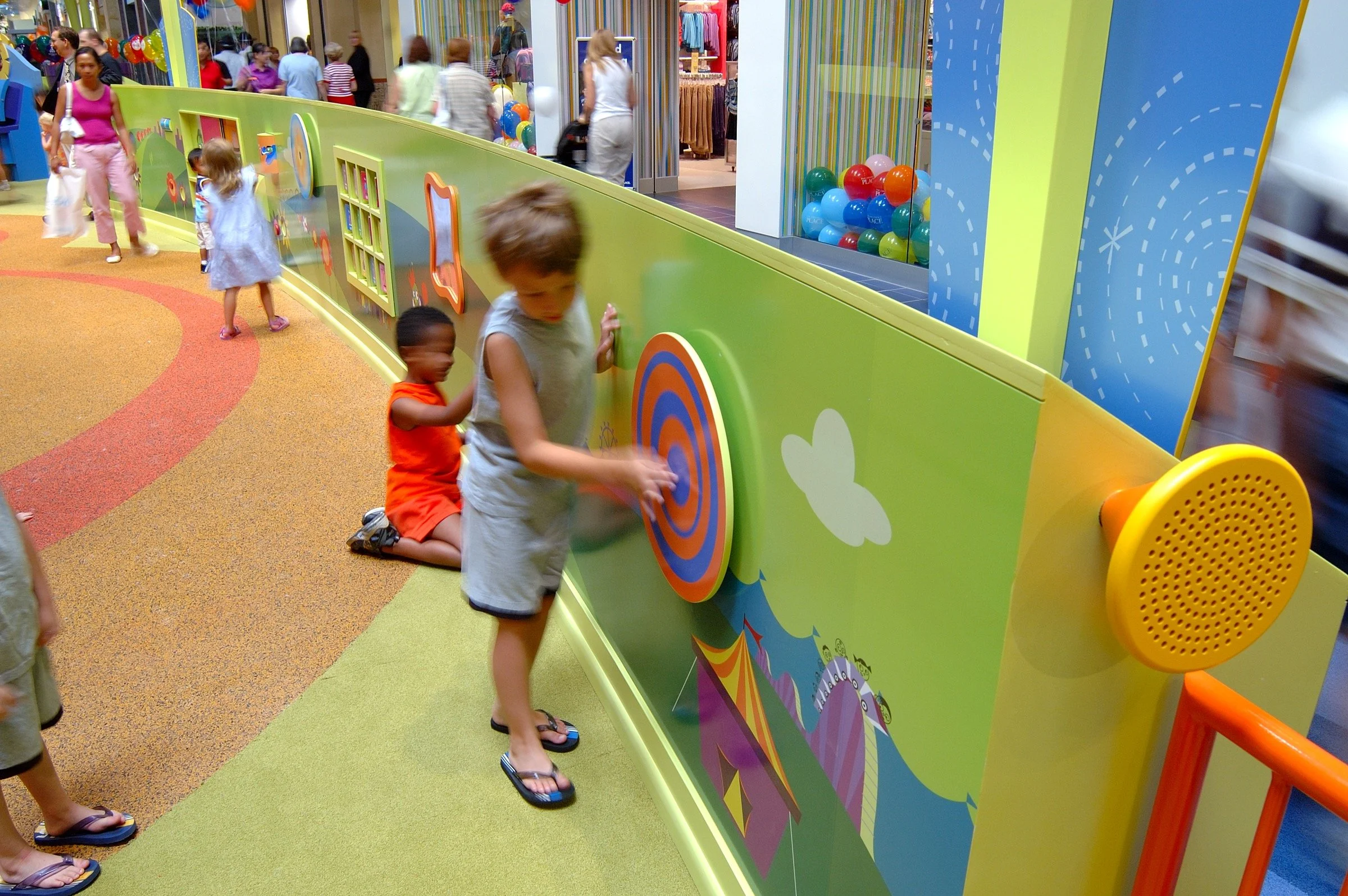 Children playing at PBS Kids Backyard play zone