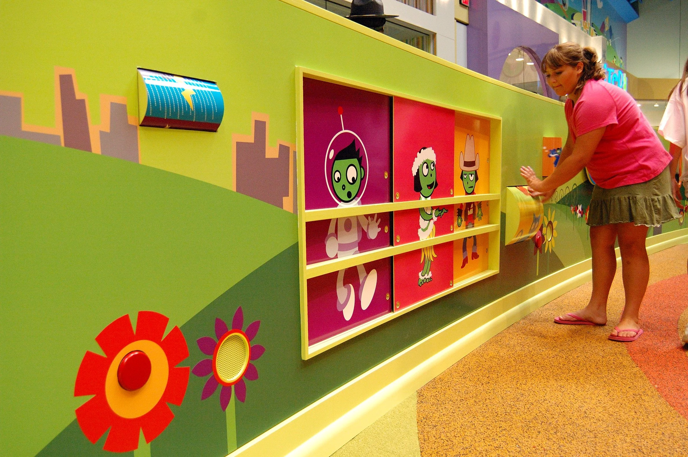 Children playing in the PBS Kids Backyard play zone.