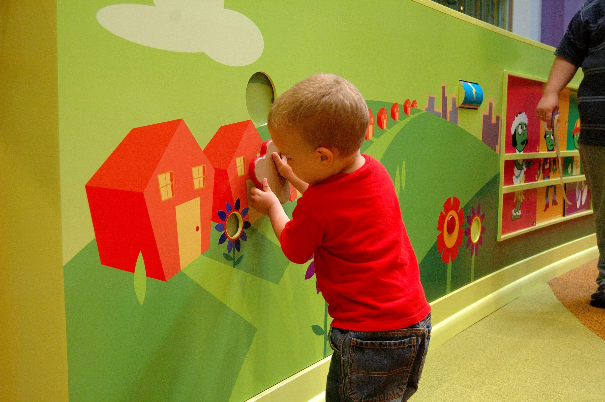 Children playing in the PBS Kids Backyard play zone.