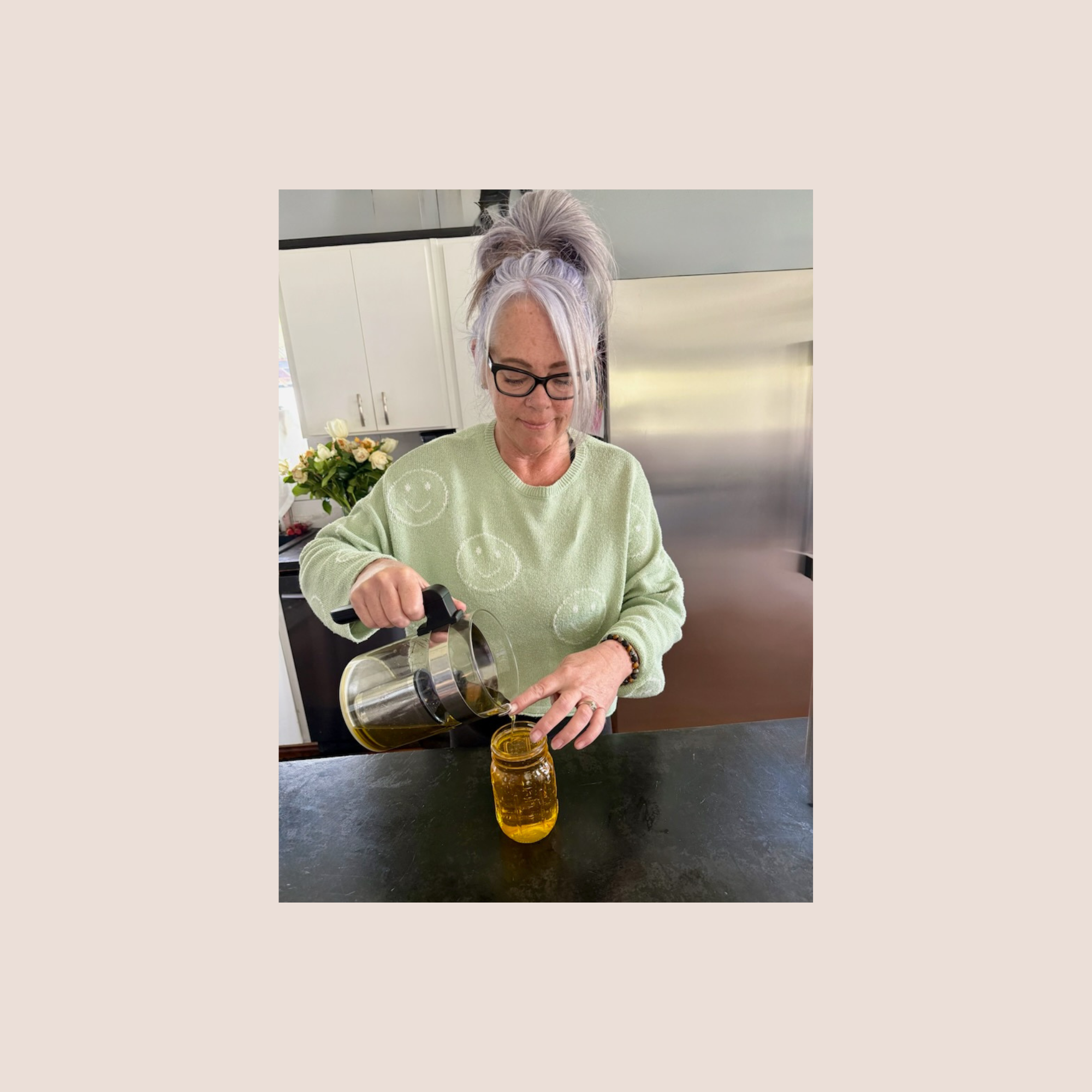 women pouring calendula infused jojoba oil to make handcrafted skin care