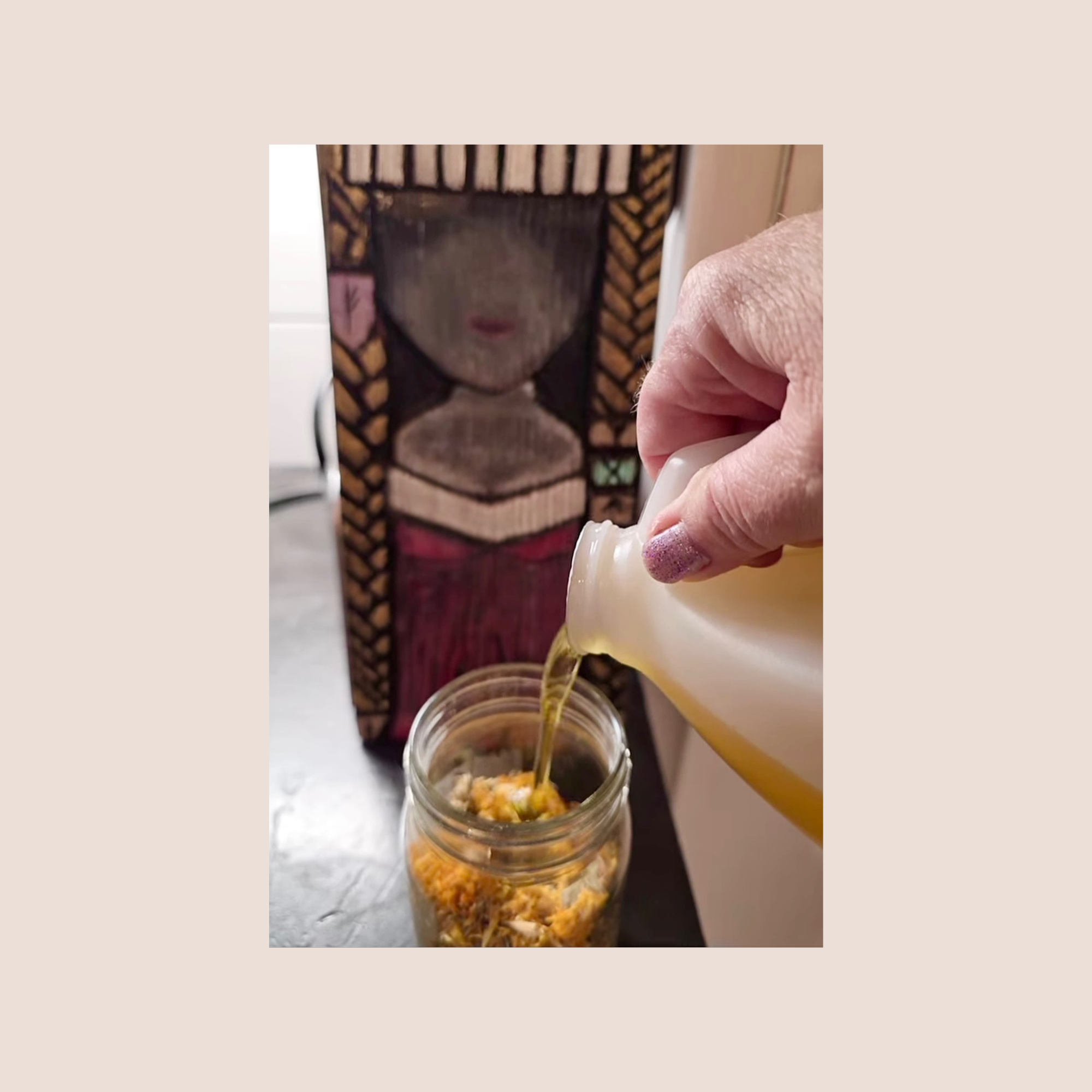 pouring jojoba oil into calendula to infuse together blessed by Thea