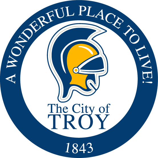 Seal of the City of Troy with a Trojan helmet and the text 'A Wonderful Place to Live! The City of Troy 1843'.
