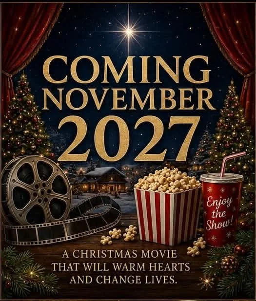 A promotional poster for a Christmas movie coming in November 2027 featuring a festive scene with Christmas trees, a film reel, popcorn, and a soda cup, with the text 'Coming November 2027, A Christmas Movie That Will Warm Hearts and Change Lives.'