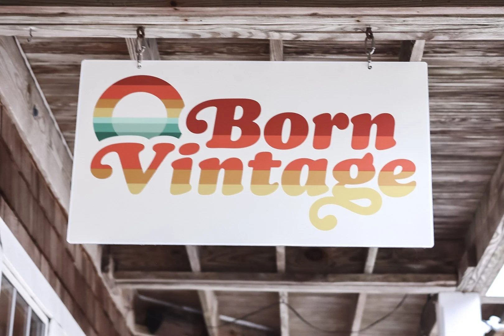 Sign that reads "Born Vintage" in retro, rainbow colors.