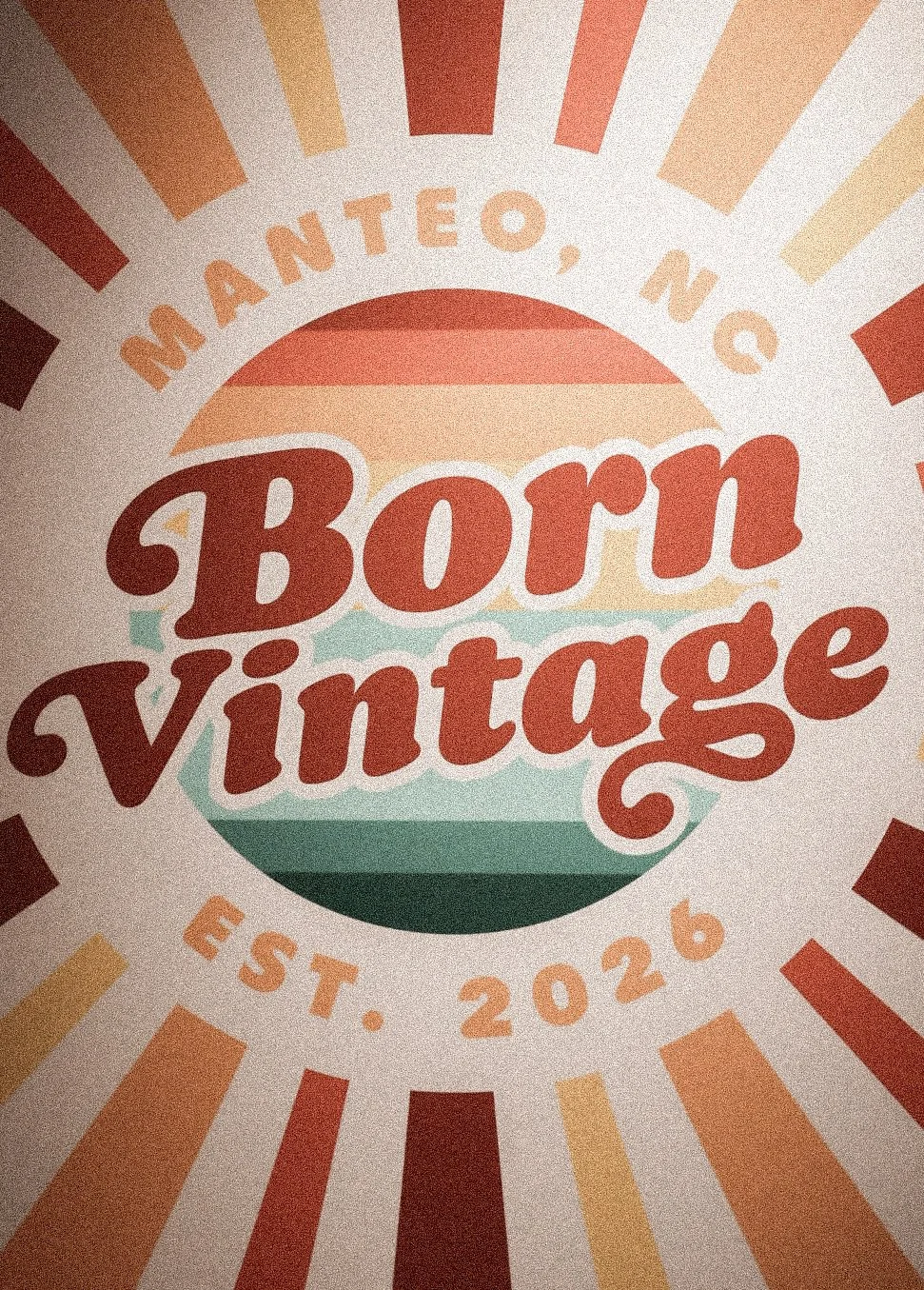 A vintage-style logo with the text 'Born Vintage' in bold red letters, surrounded by orange, yellow, and red rays, with additional text 'Manteo, NC' at the top and 'Est. 2026' at the bottom.