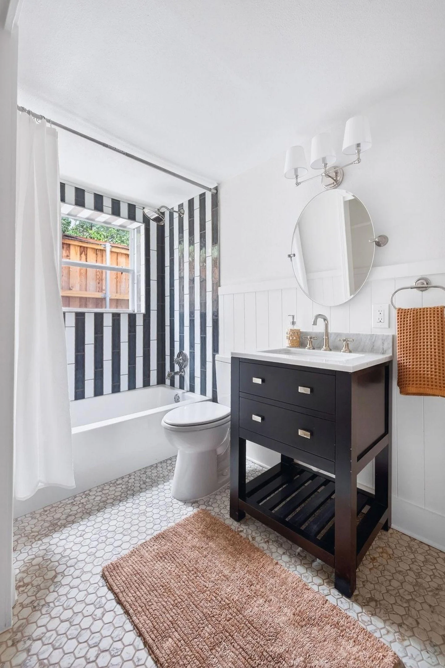 Project Spotlight: A clean, modern-rustic bathroom refresh featuring marble hex floors and bold vertical accent tile. We love how the dark wood vanity grounds this bright space.

📍 Serving the Austin &amp; Hill Country area.
🔗 Tap the link in bio t