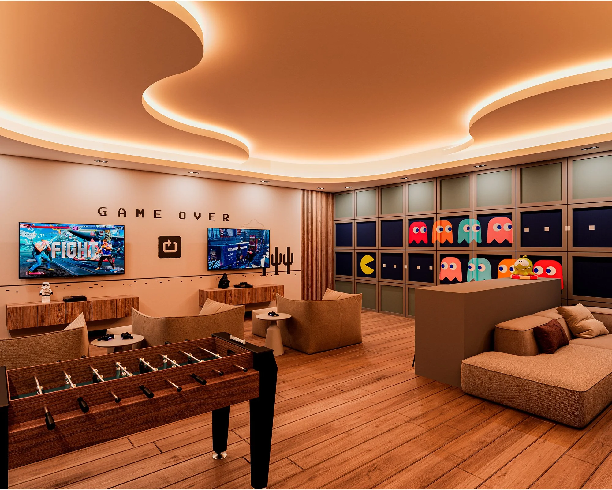 Una sala de entretenimiento con televisores, sofá y una mesa de futbolín, decorada con figuras de los videojuegos Pac-Man y personajes de arcade, y una pared que dice 'Game Over'.
