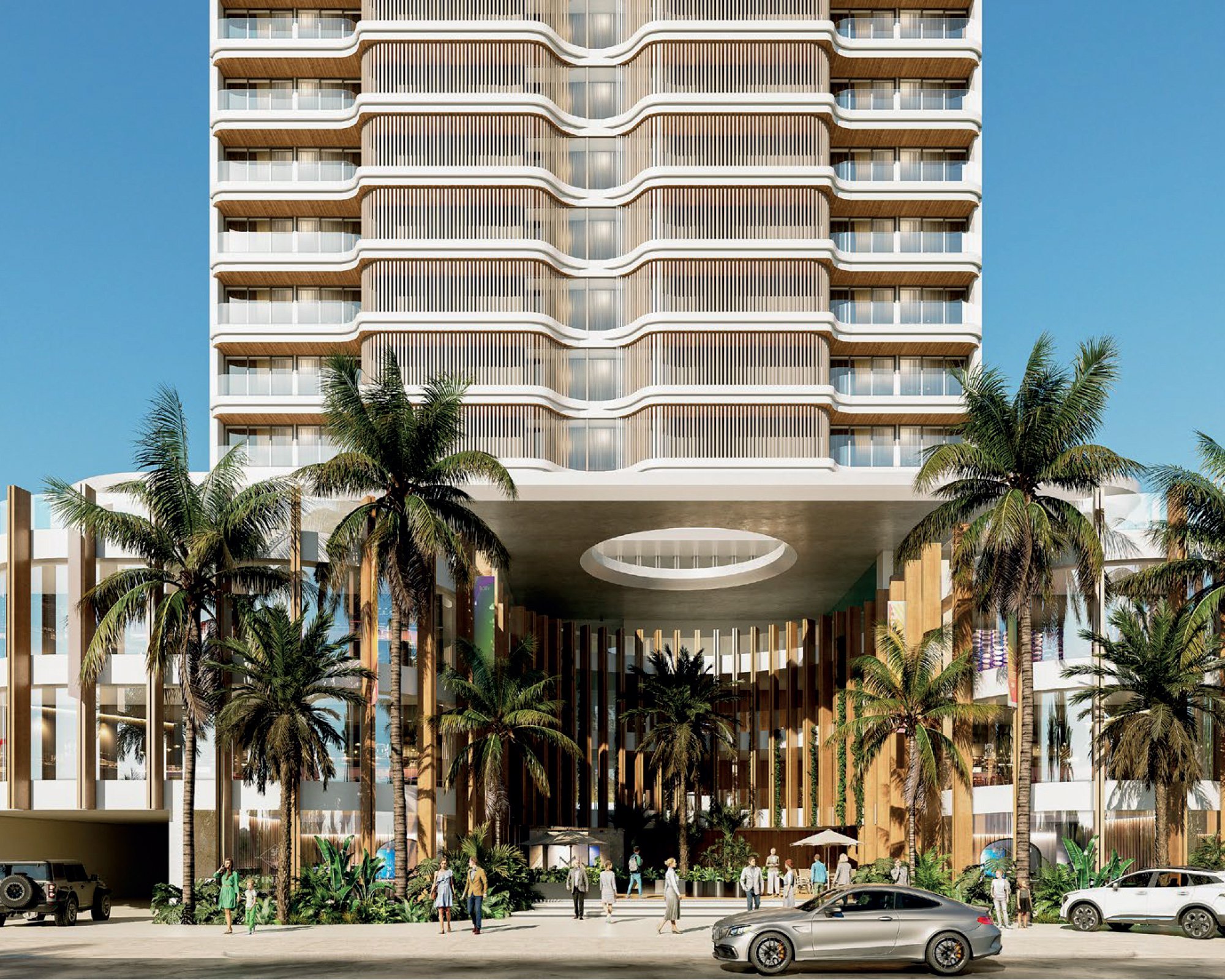 Edificio moderno de varios pisos con balcones curvos de madera y estructura de columnas en la entrada, rodeado de palmeras y vehículos en la calle frente a él, bajo un cielo azul