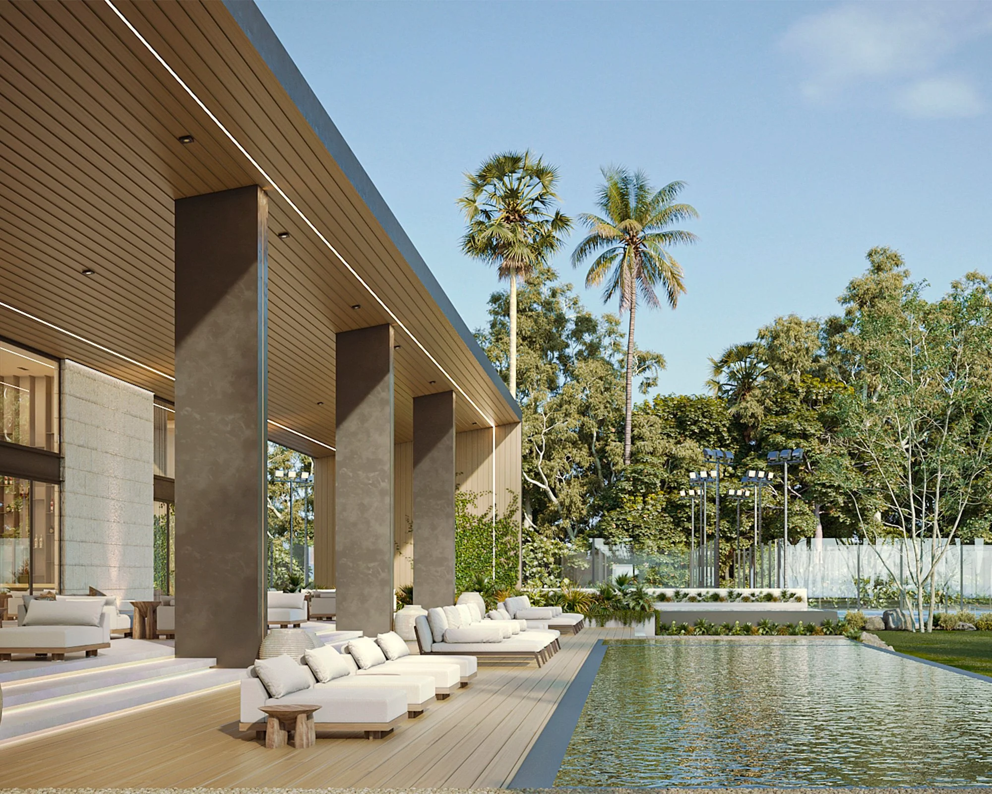 Exterior de una casa moderna con piscina, decorada con muebles blancos y rodeada de árboles y palmeras en un día soleado.
