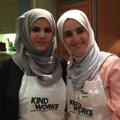 Noor and Basma, for whom KindWorks set up apartments, teach a Syrian cooking class.