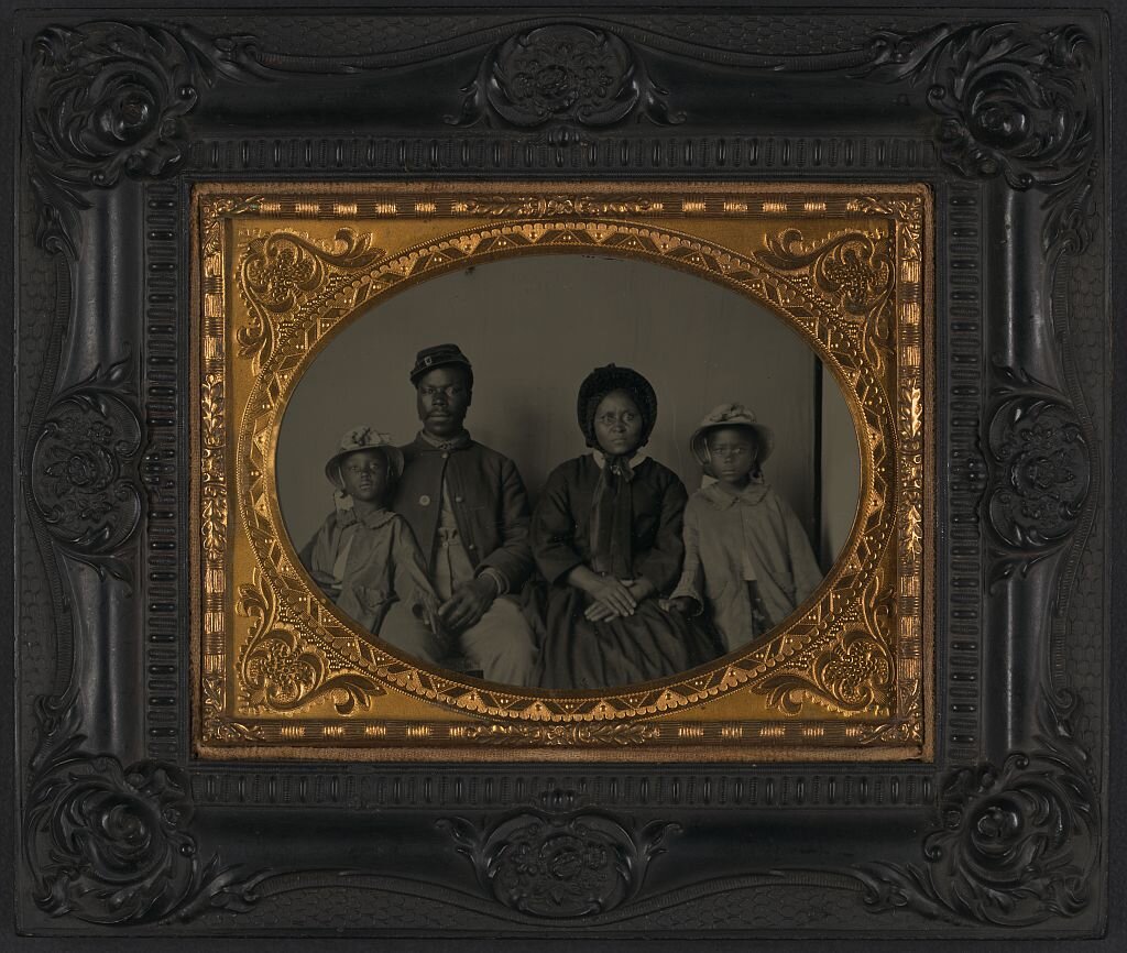 Unidentified African American soldier in Union uniform with wife and two daughters, between 1863 and 1865; Library of Congress.