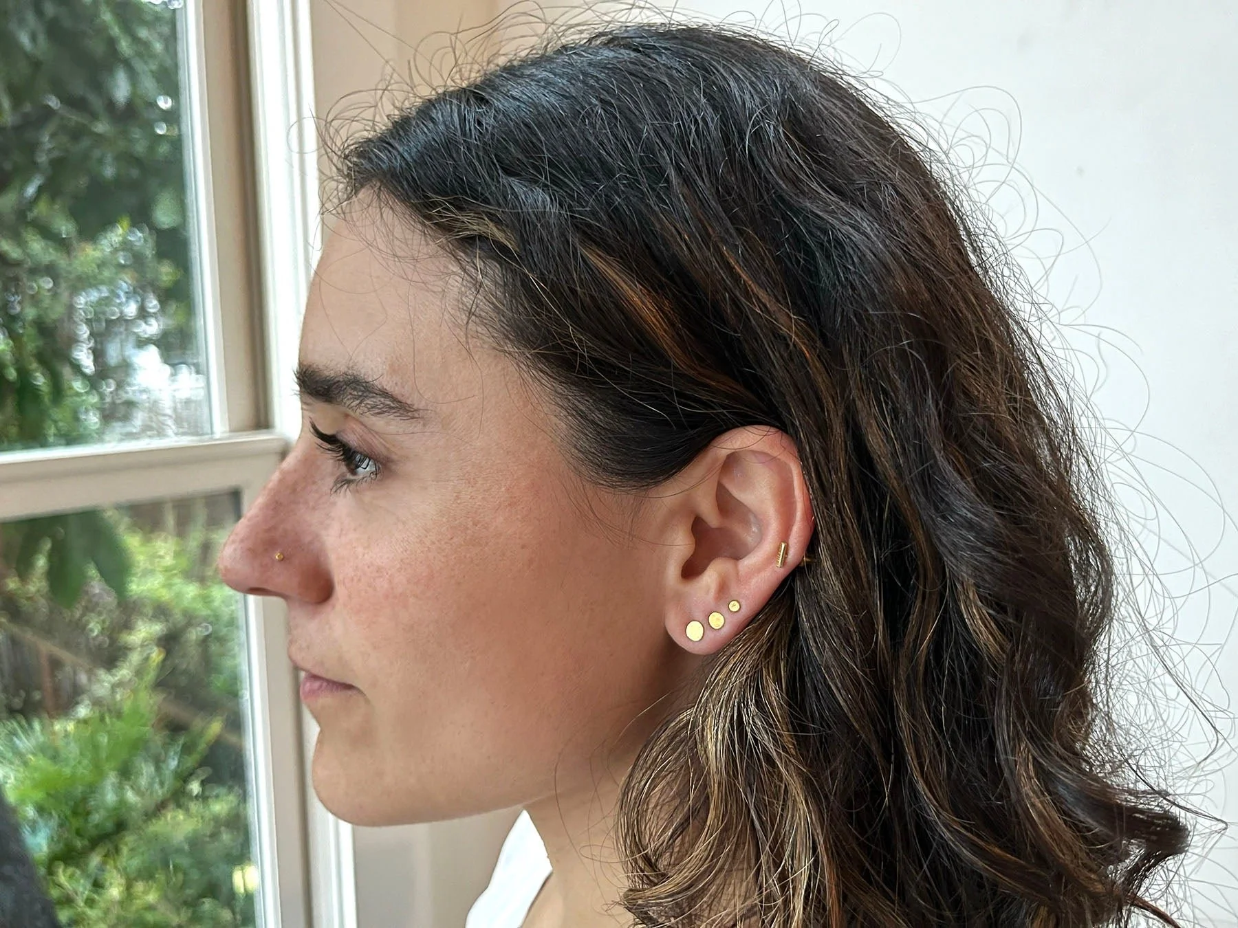earring stack of 5mm, 4mm, and 2.5mm hammered 24k gold everyday earrings studs with 18k posts
