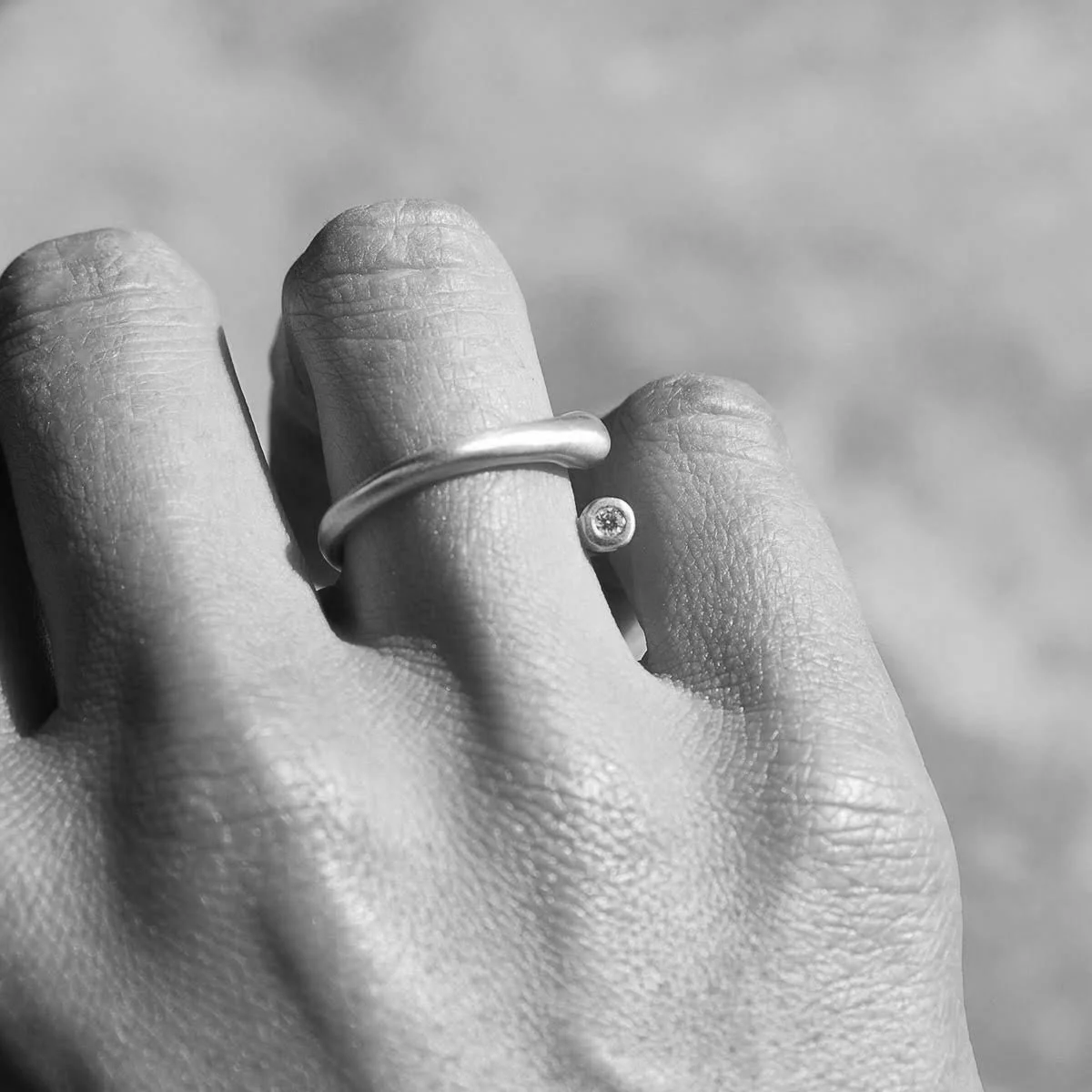 size 6.5 adjustable tapered smooth rounded 18k yellow gold ring with a split with a 2.2mm diamond