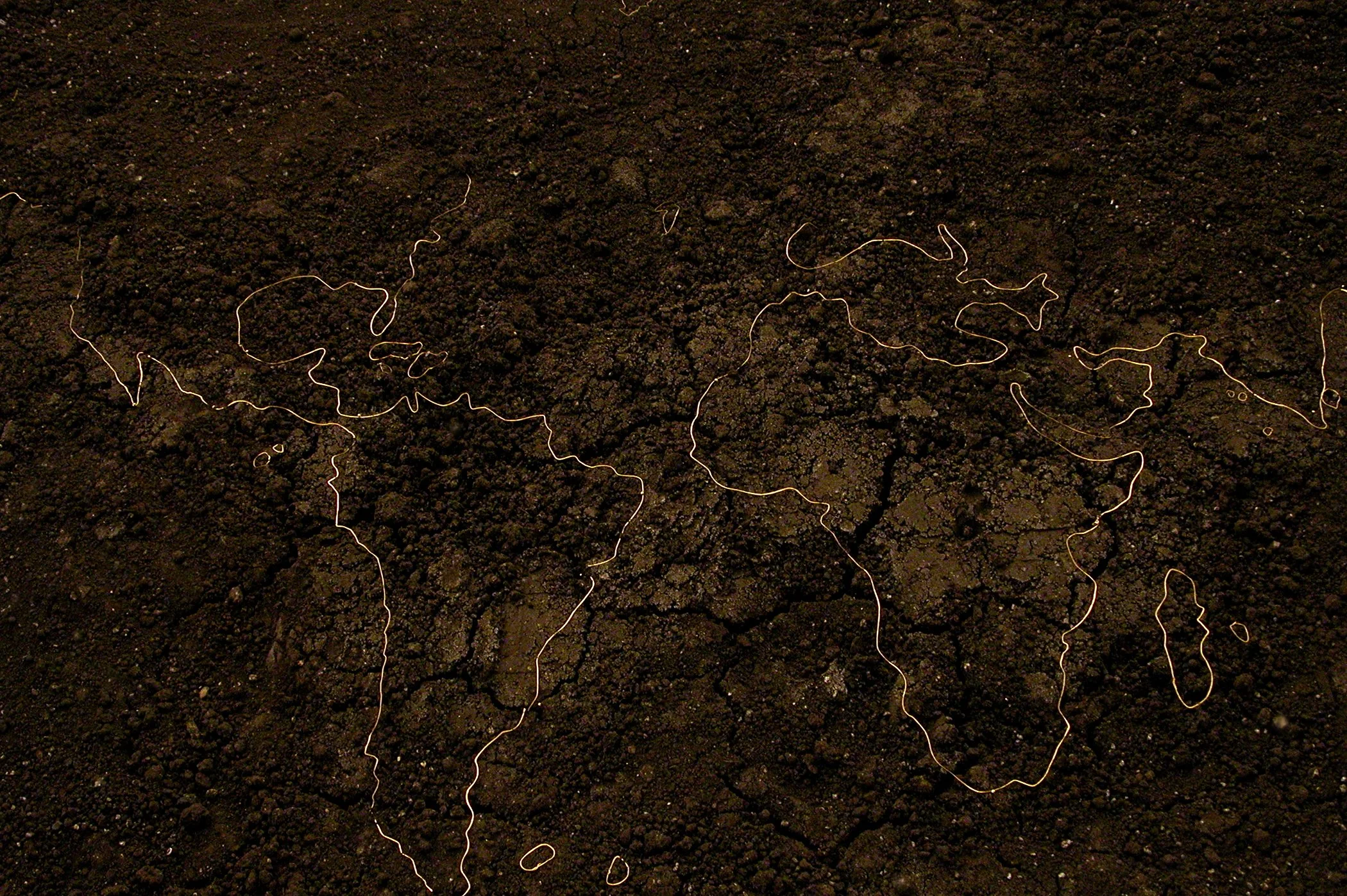 A map of the world in black and gold.