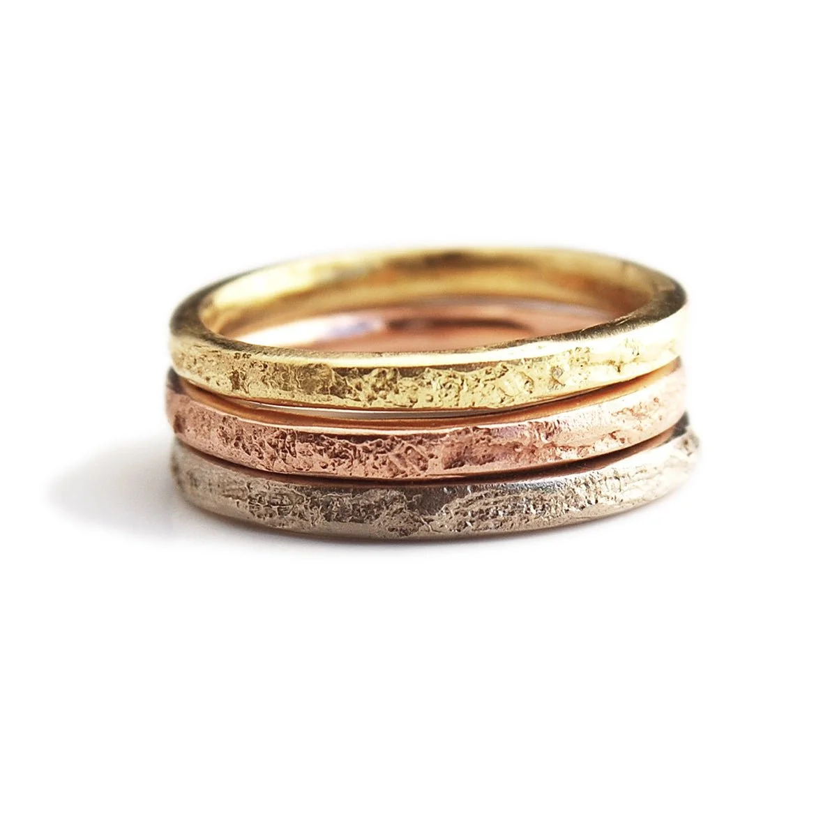 assorted 2mm 18k yellow gold, 14k rose gold, and platinum silk textile textured rings