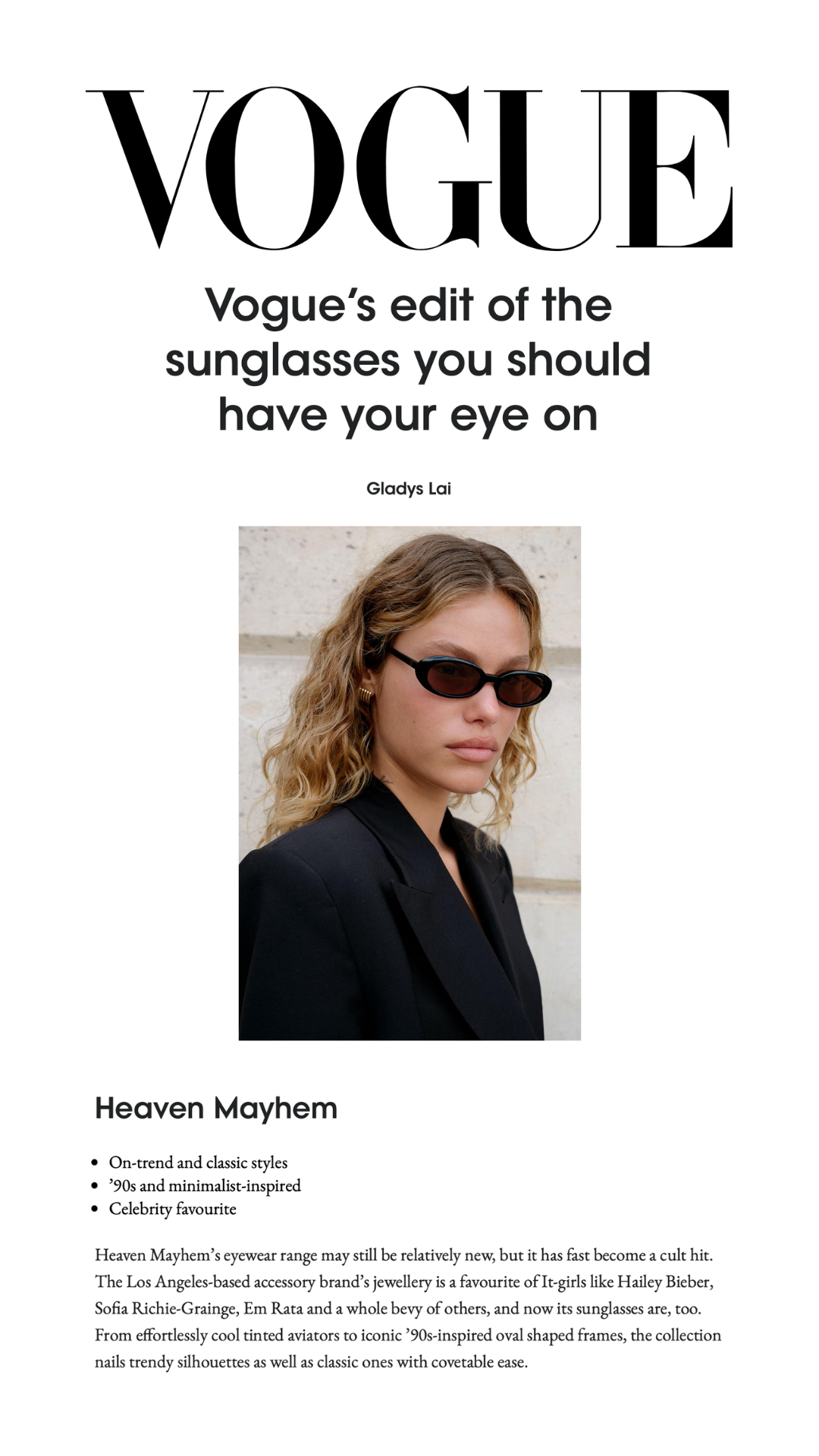 Vogue magazine cover featuring a woman with wavy hair wearing black sunglasses and a black blazer, with text about sunglasses and fashion.
