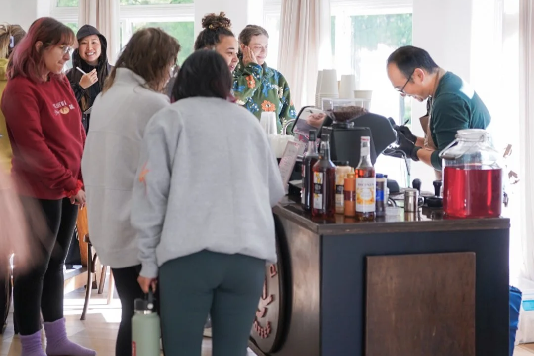 Employees gathered around a mobile espresso bar at a corporate event in Asheville North Carolina