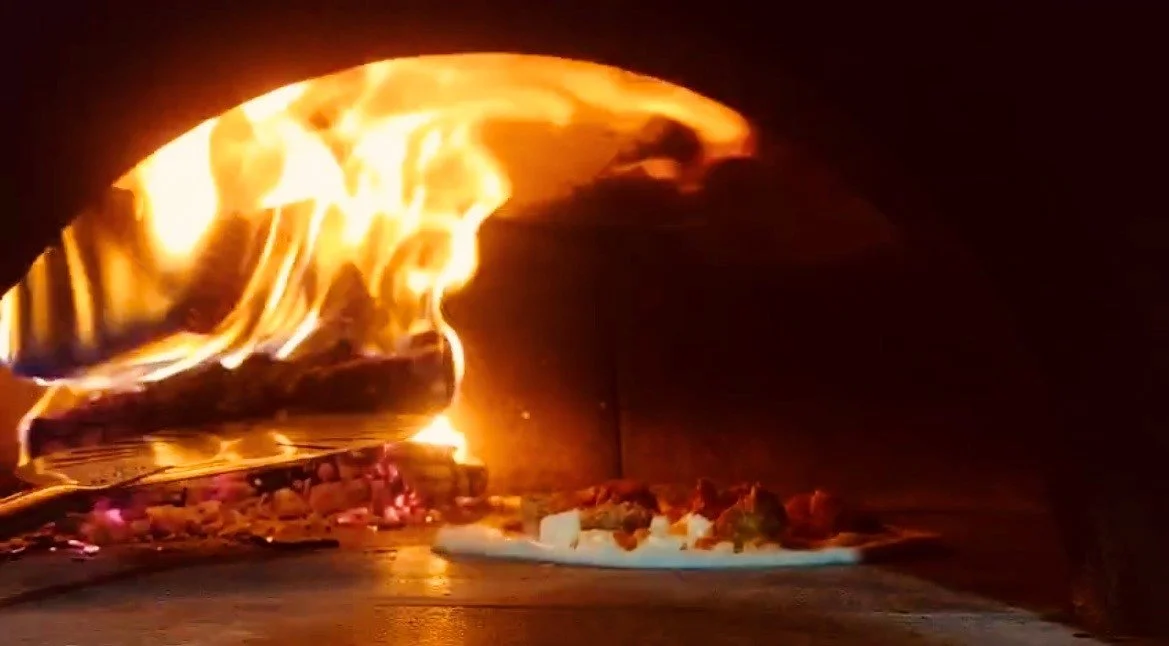 Wood fired oven with pizza.jpg