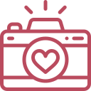 Pink camera with a heart symbol on the front
