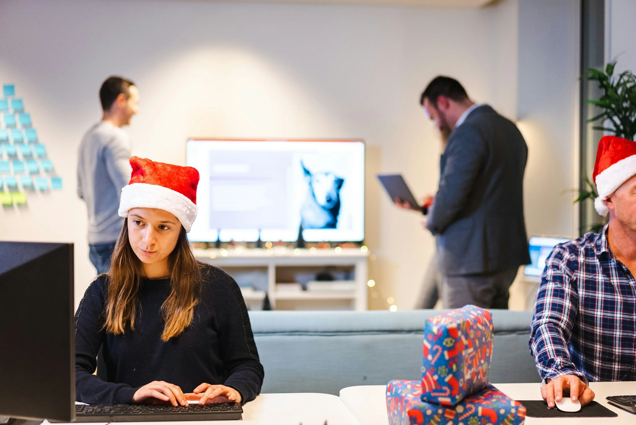 Employees wearing Santa hats and feeling festive for the holiday season.