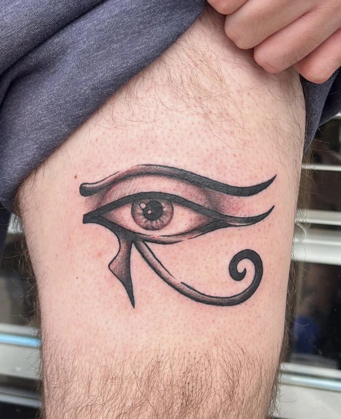 Tattoo of the Eye of Horus symbol on a person's upper leg completed in the Denver West Metro.
