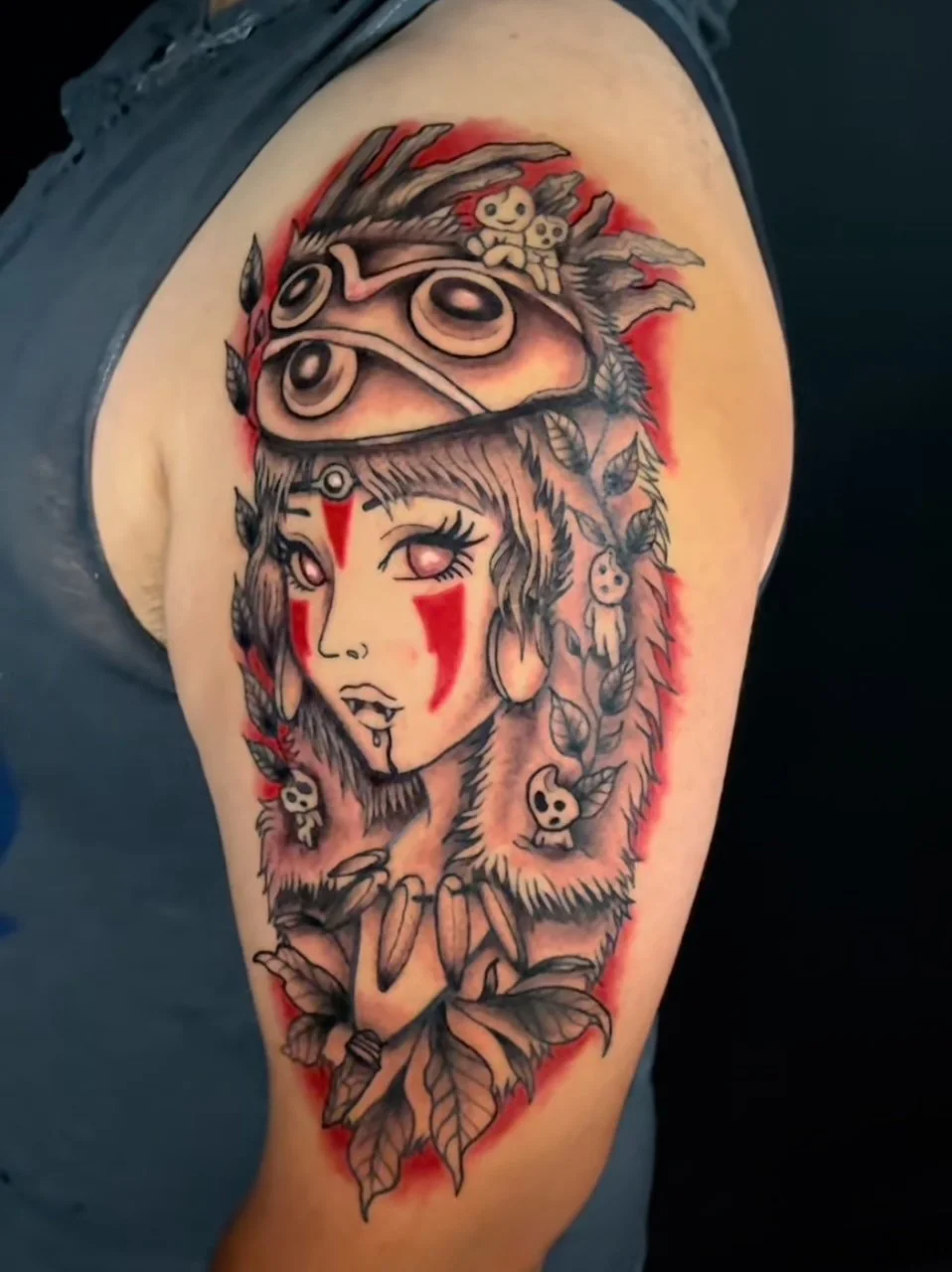 Red, black and gray tattoo of Princess Mononoke, done by our artist Colton off of 44th Ave.