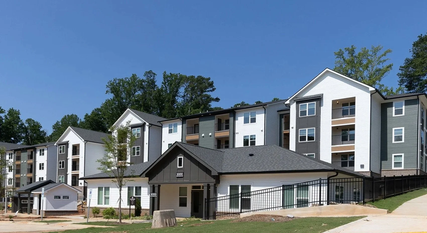 Exterior of a multifamily apartment with dark grey and white exterior