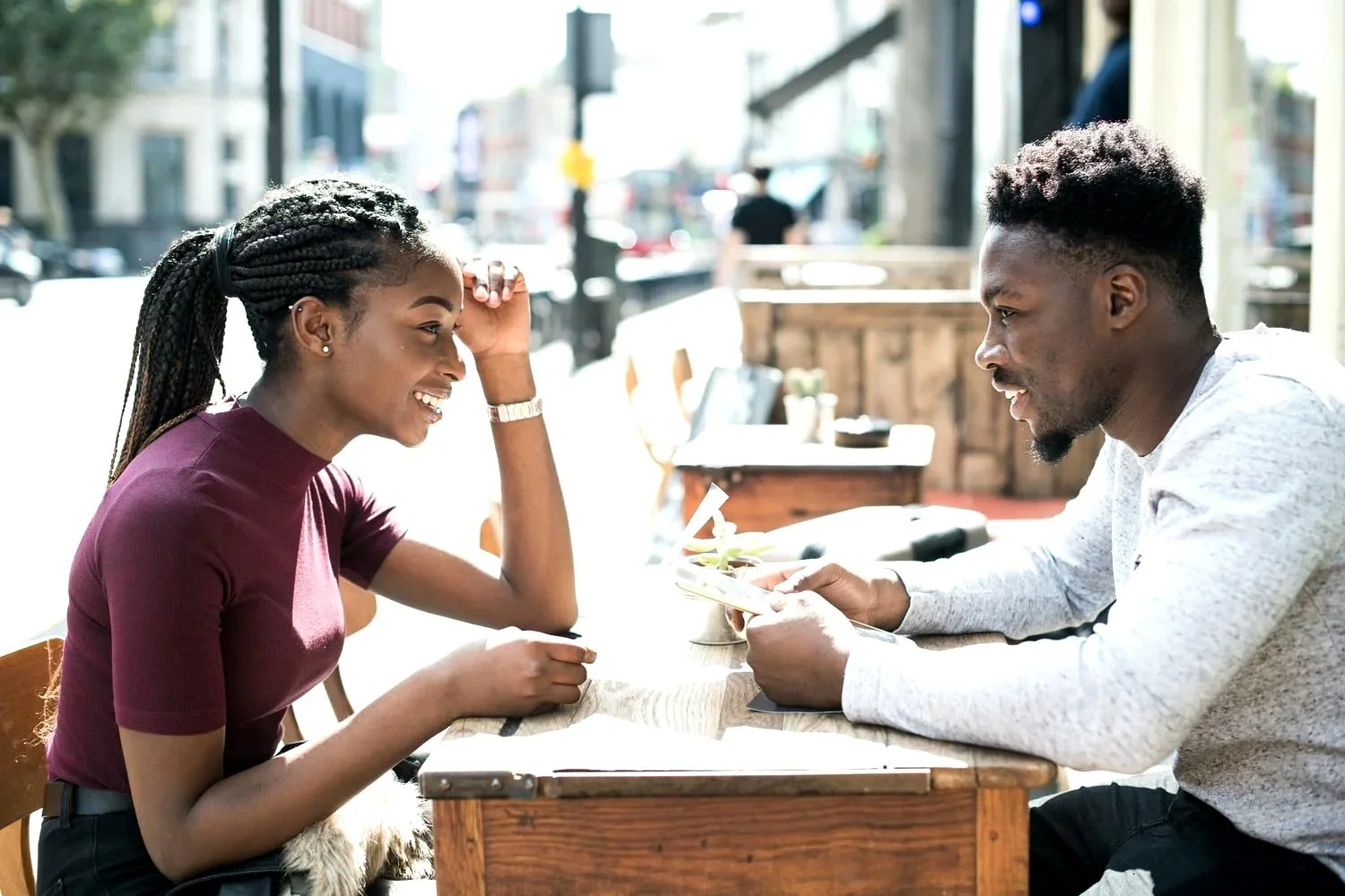 Young adult couple sitting together at a wooden table
