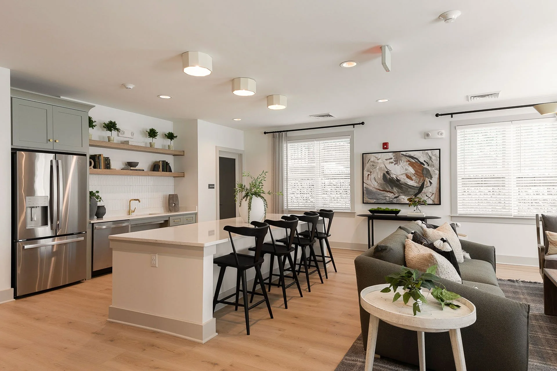Community room kitchen with large island at The Pines at Peach Road