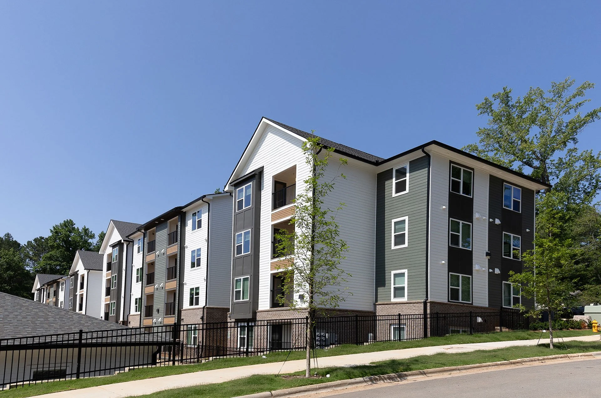 Exterior with white and grey siding at The Pines at Peach Road