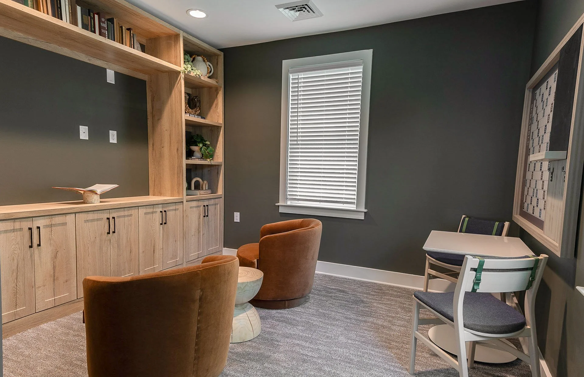 Community room with dark walls at The Pines at Peach Road
