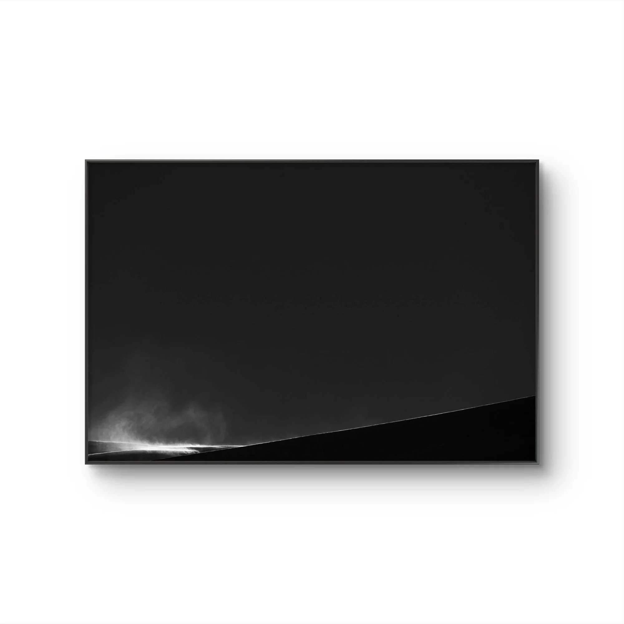 Un téléviseur noir avec un cadre fin, affichant un écran noir, placé contre un mur blanc dans une pièce moderne.